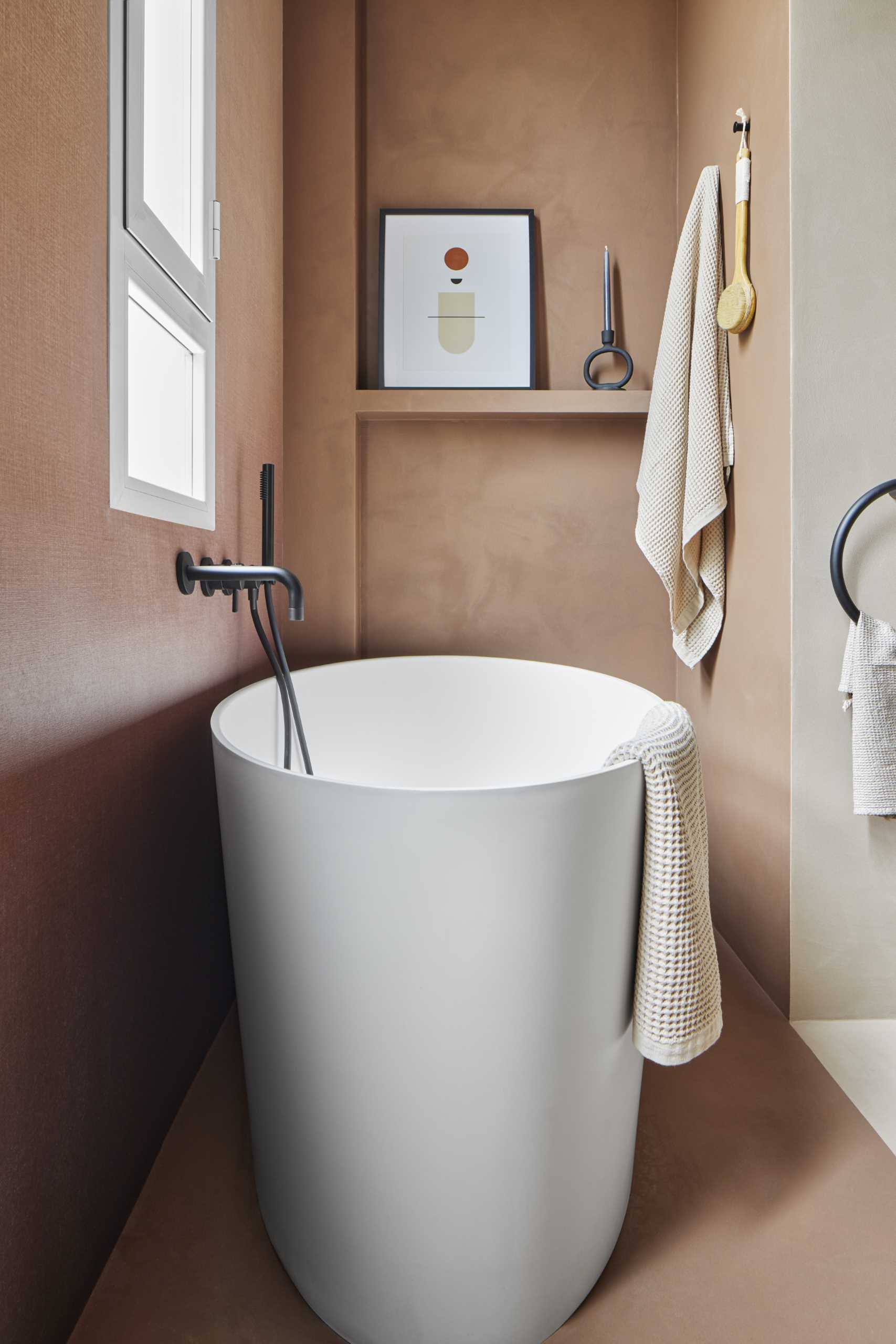 A modern bathroom with a freestanding bathtub.