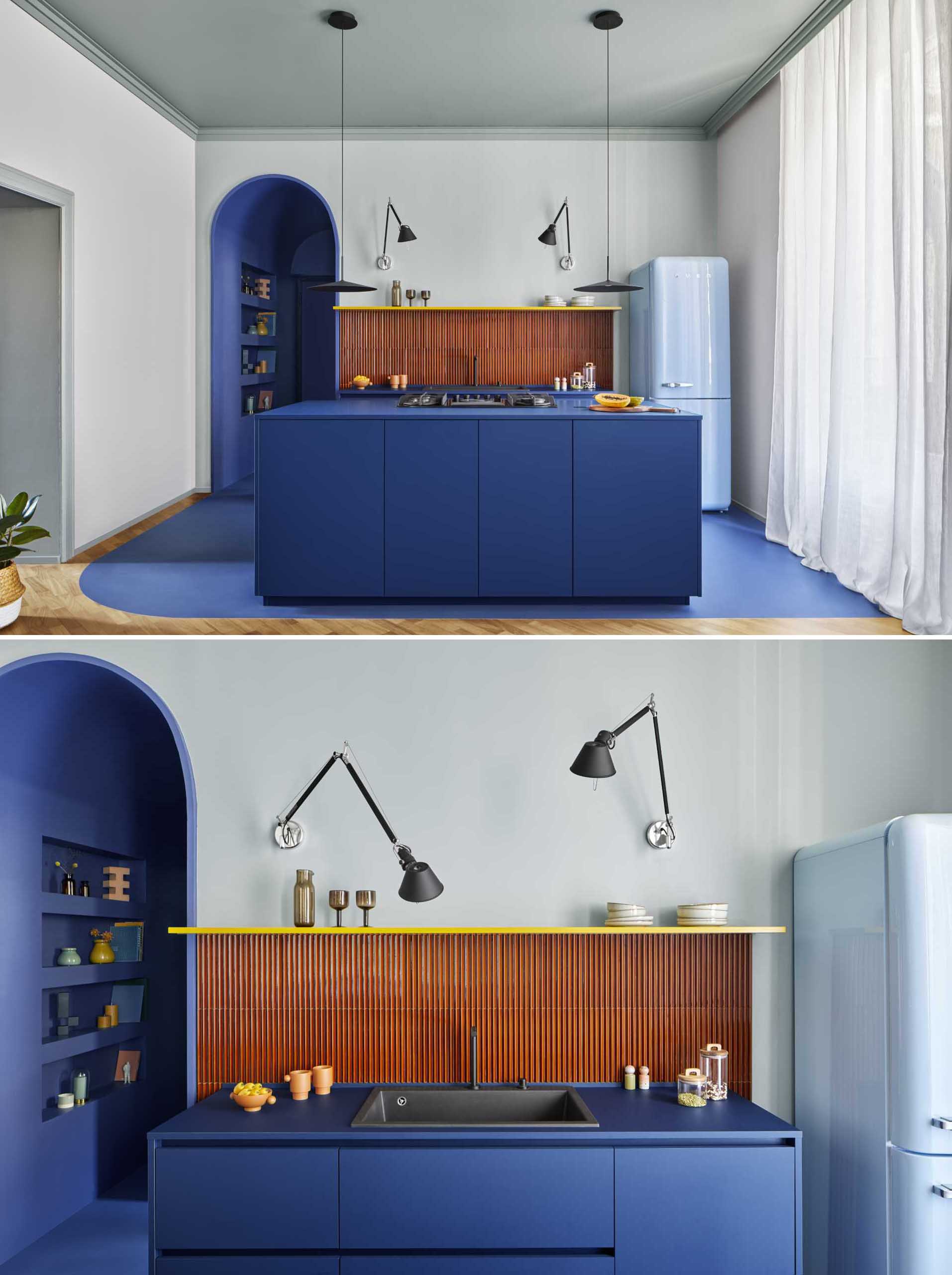 This kitchen has been defined in the open-plan room by using blue, which matches the entrance corridor. The Iroko wood floor was removed and replaced with a cement material in the same shade of blue.