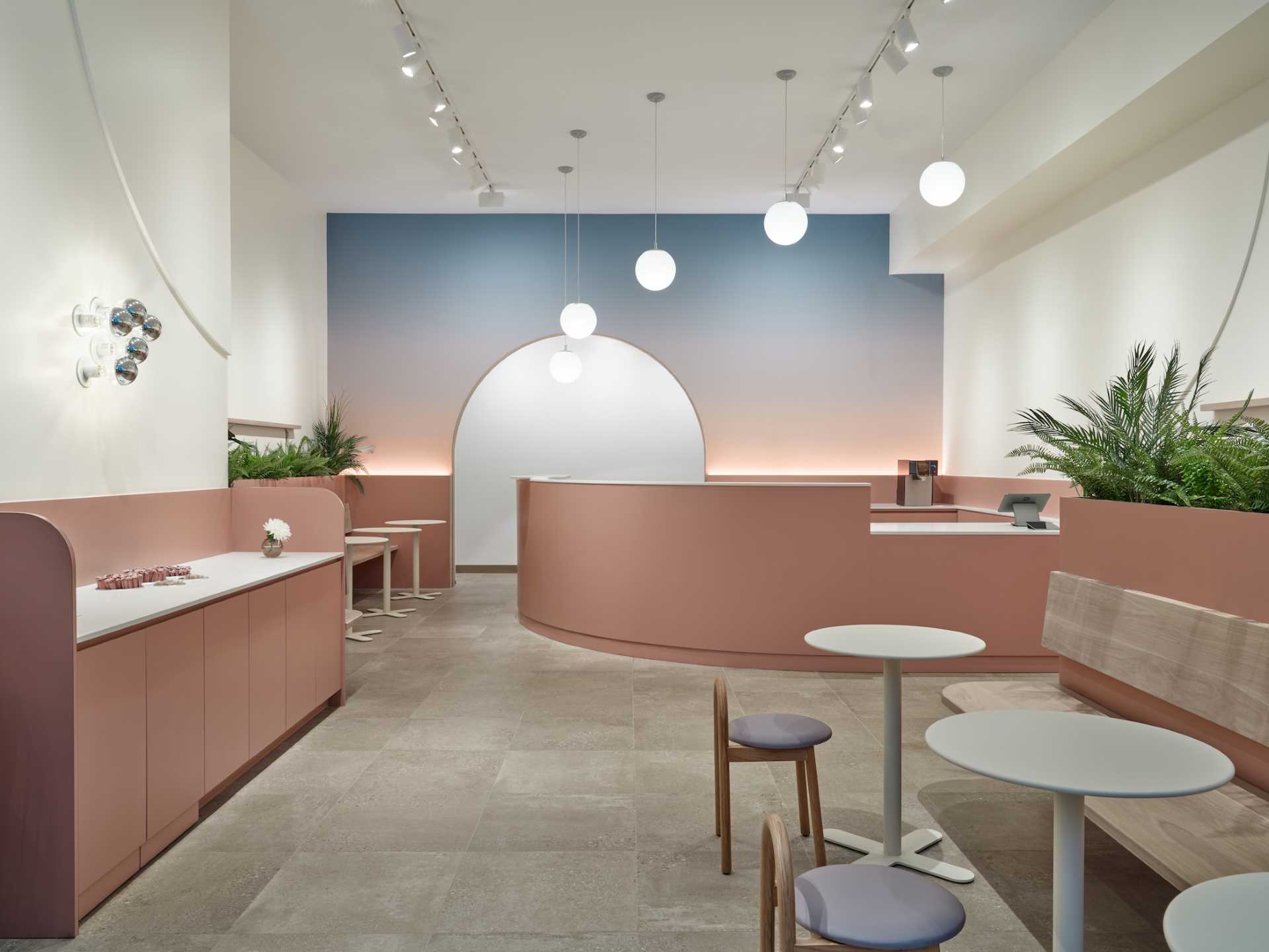 A modern cafe with a calm and relaxed atmosphere, a colorful feature wall. and curved designs.