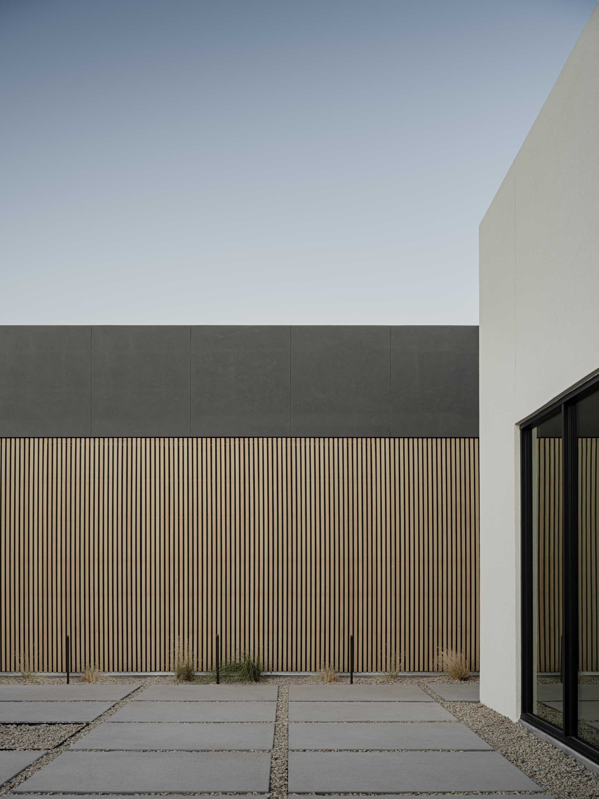 A modern home with an exterior feature wall made from Hemlock slats.