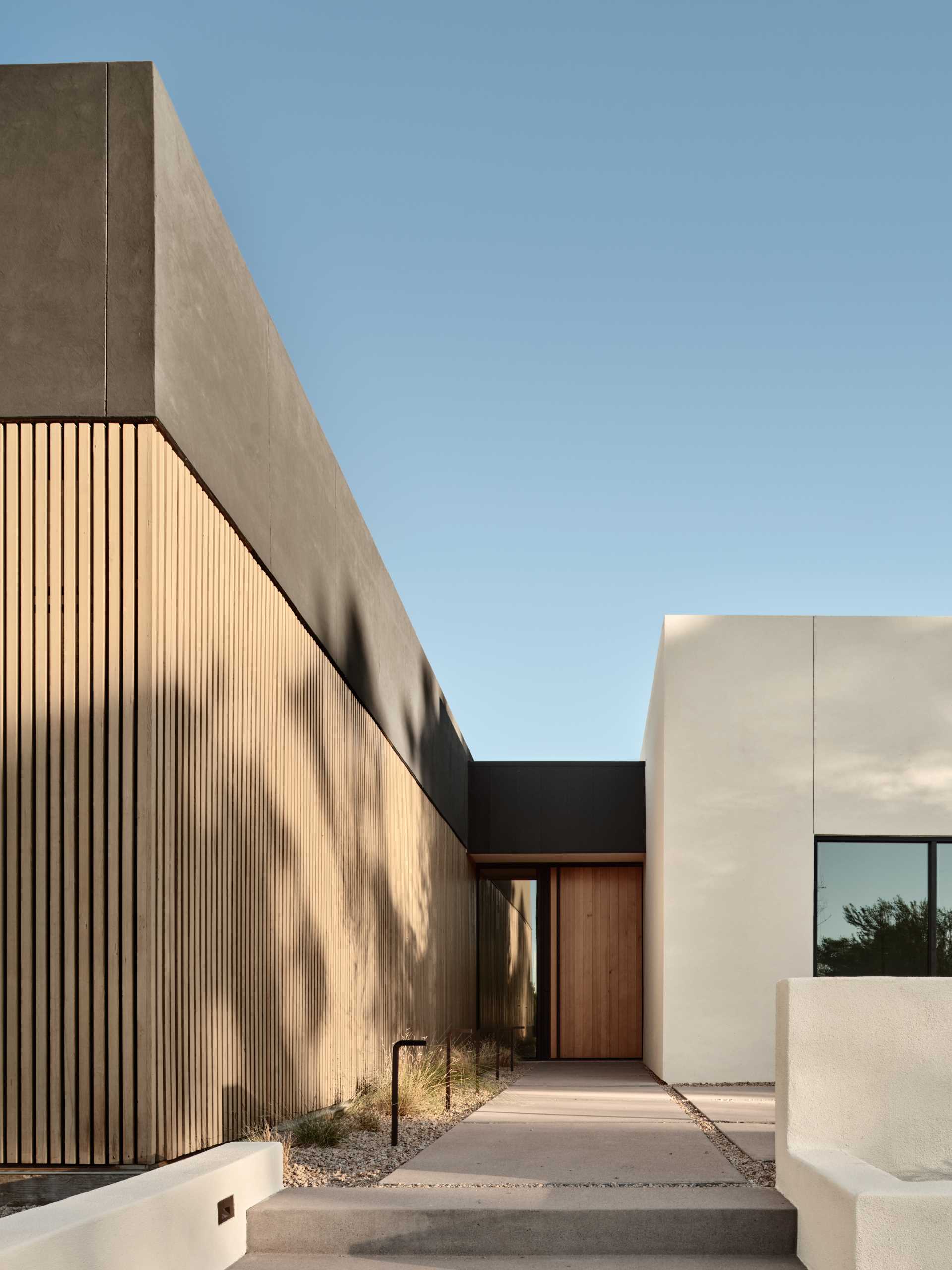 A modern home with an exterior feature wall made from Hemlock slats.