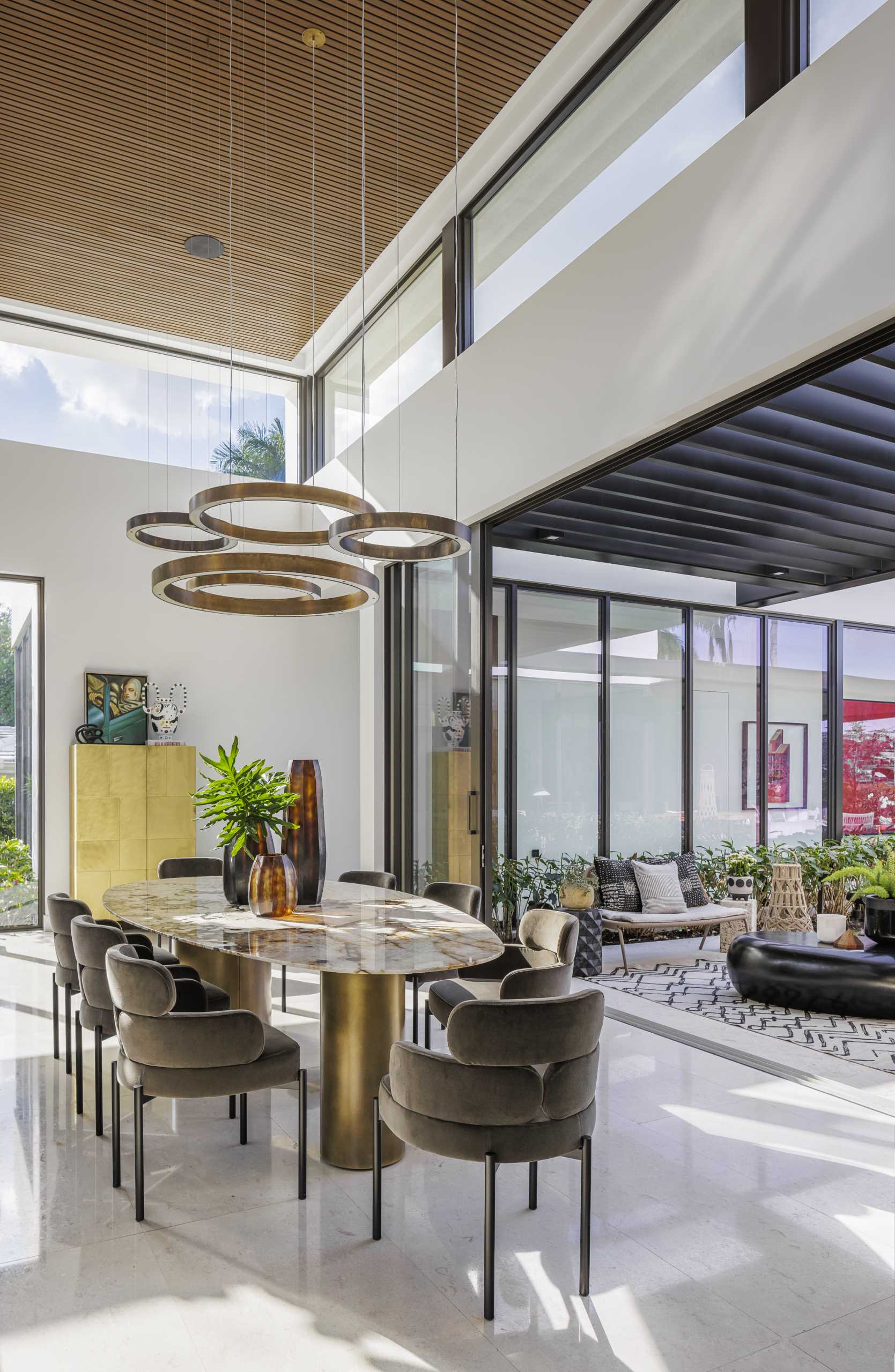 In the living room, dining room, and kitchen, there are elevated ceilings and clerestory windows that have been included to enhance the connection with nature.