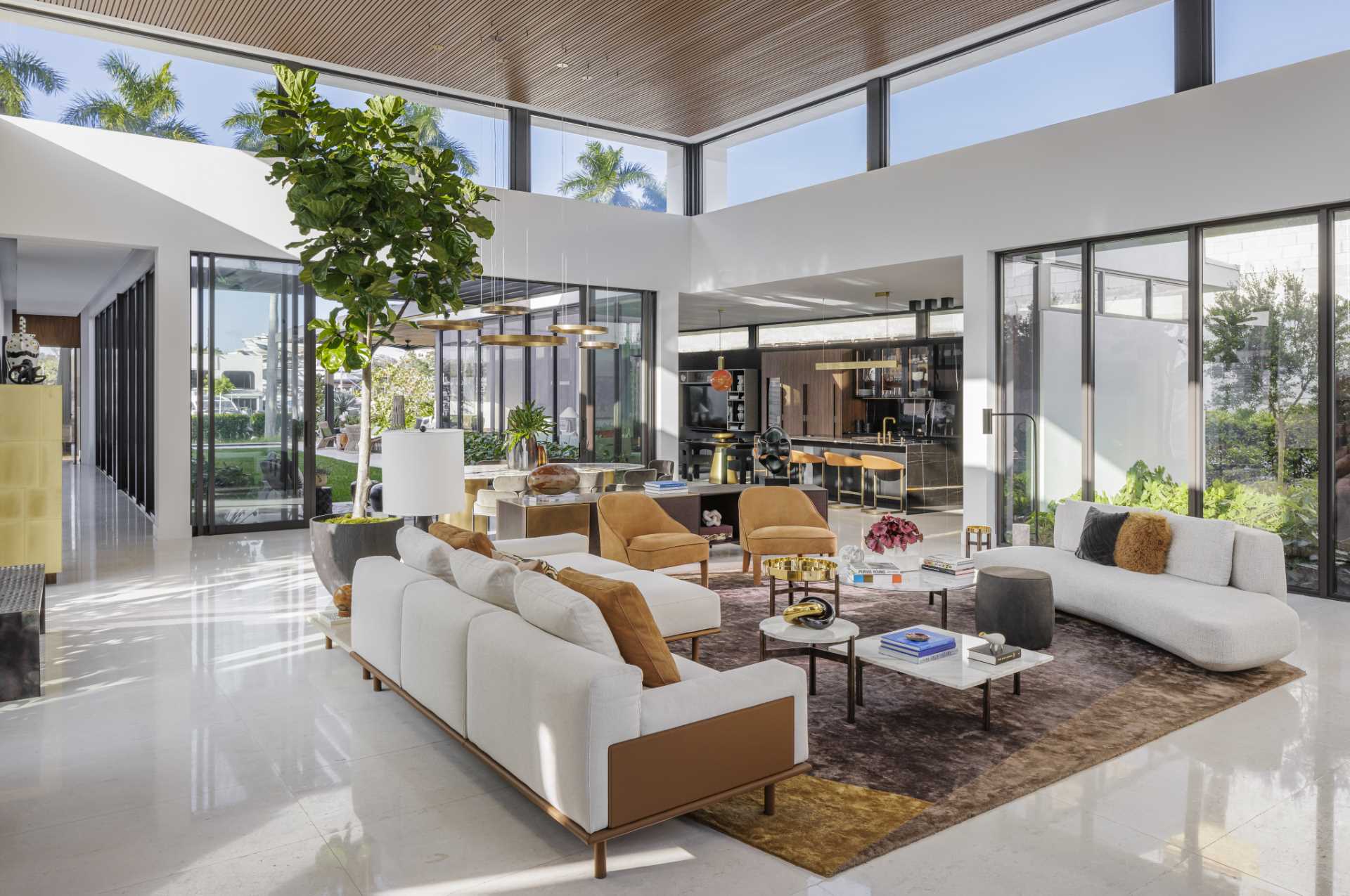 In the living room, dining room, and kitchen, there are elevated ceilings and clerestory windows that have been included to enhance the connection with nature.