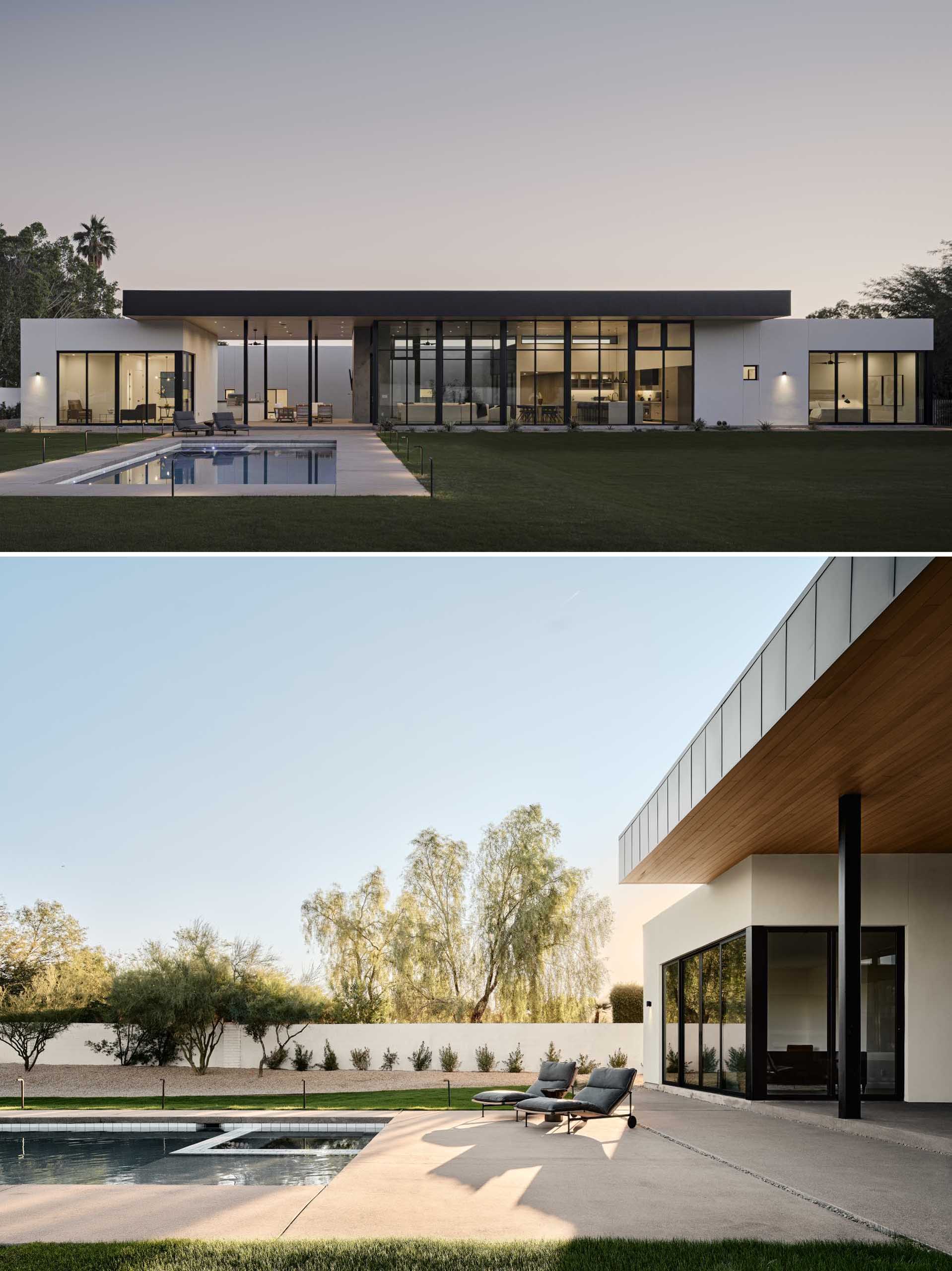 A modern house with large glass walls, an outdoor living room, and a swimming pool.