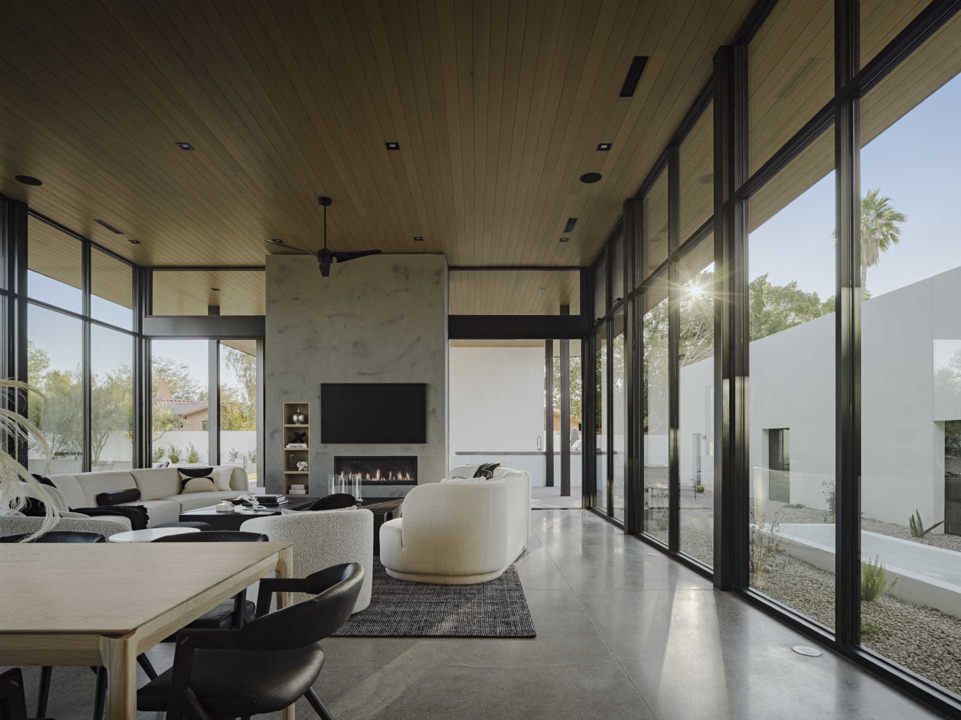 Pocketing glass doors hidden behind the plastered fireplace create a seamless connection to the patio.