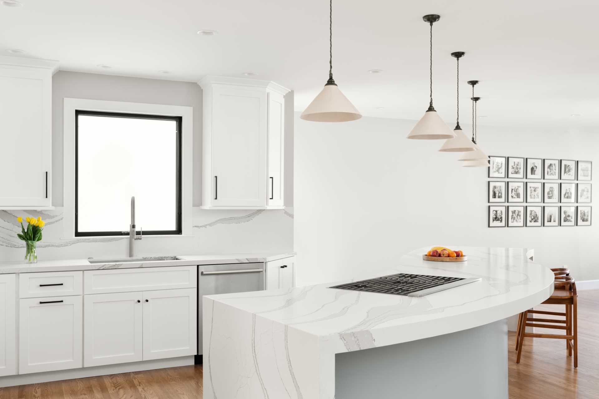 A modern kitchen with a curved kitchen island.