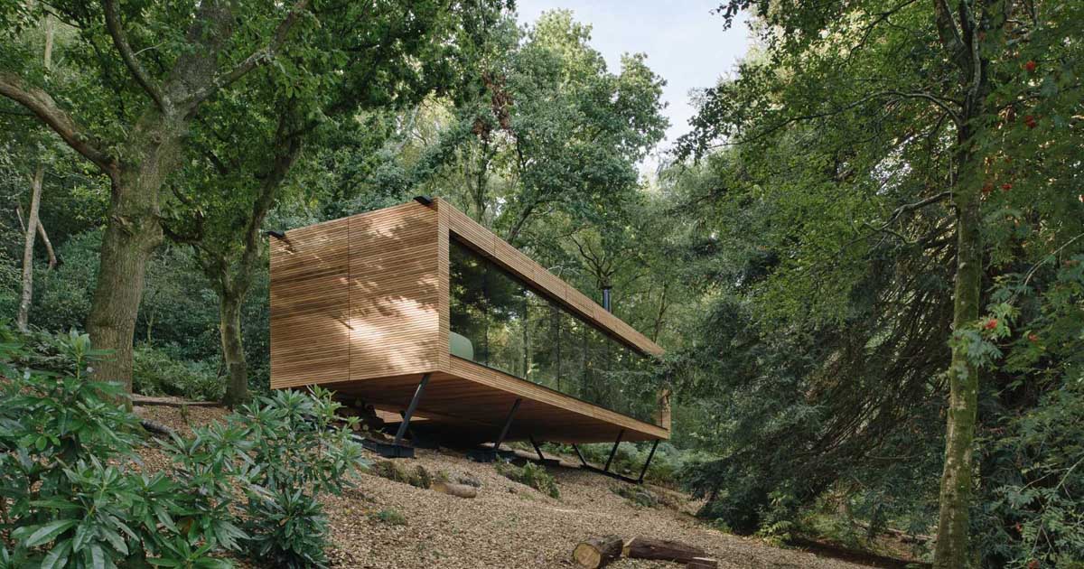 This Wood Covered House Hovers Above The Hillside In The Forest