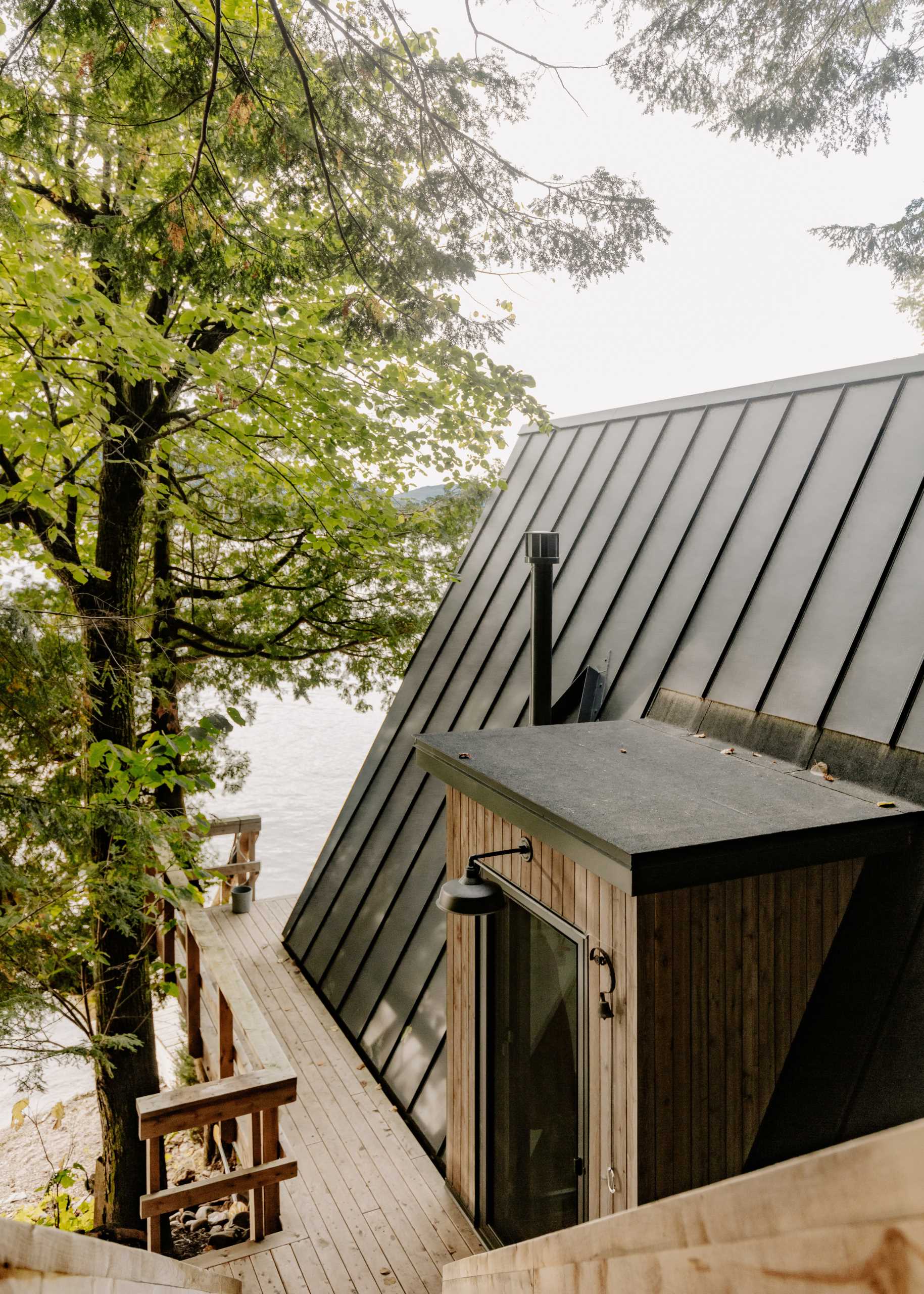 An A-Frame cabin with dark exterior.