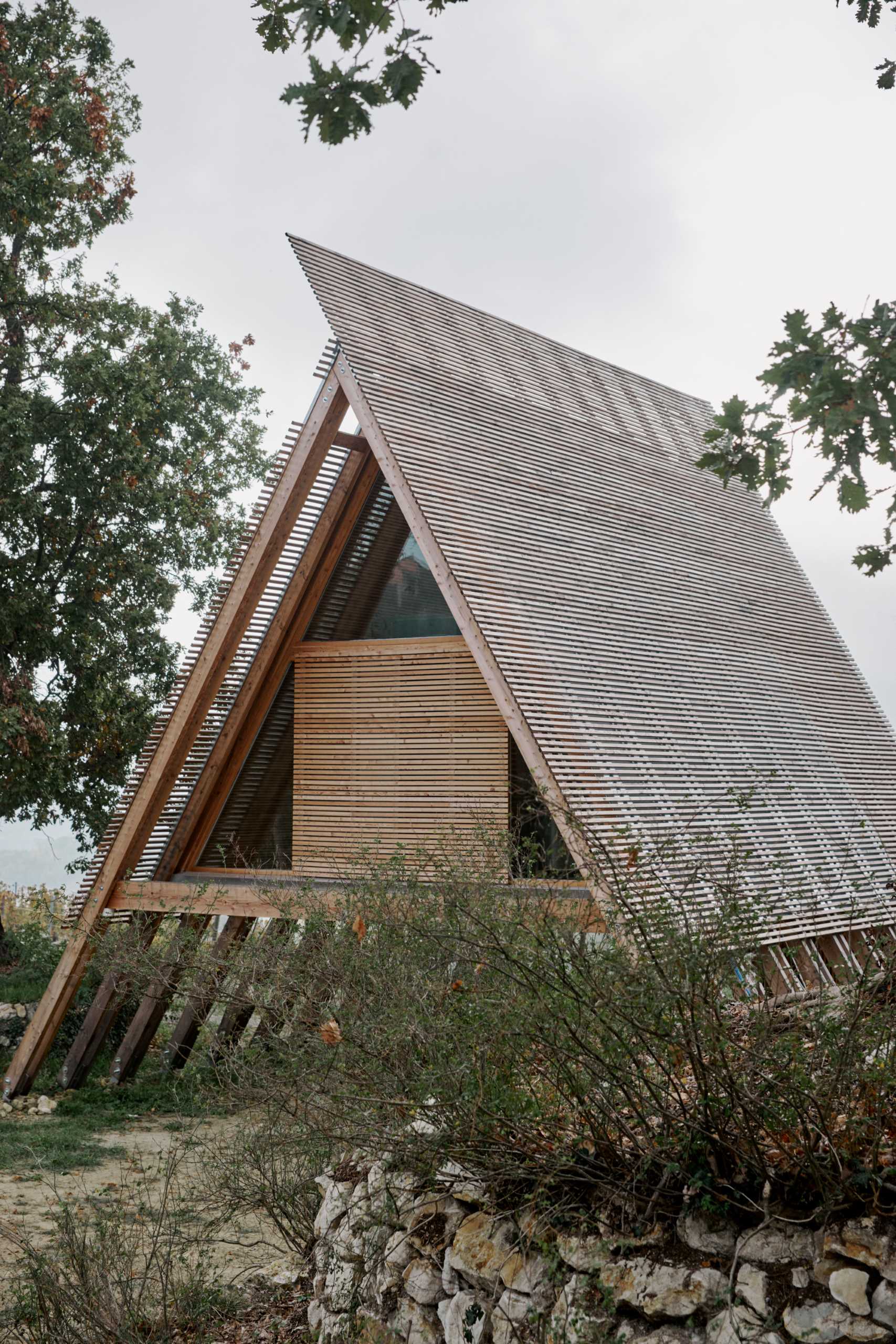 This modern A-frame cabin is made of larch treated only with oil, a natural element that’s absorbed into the wood, enriching and nourishing it as it ages.