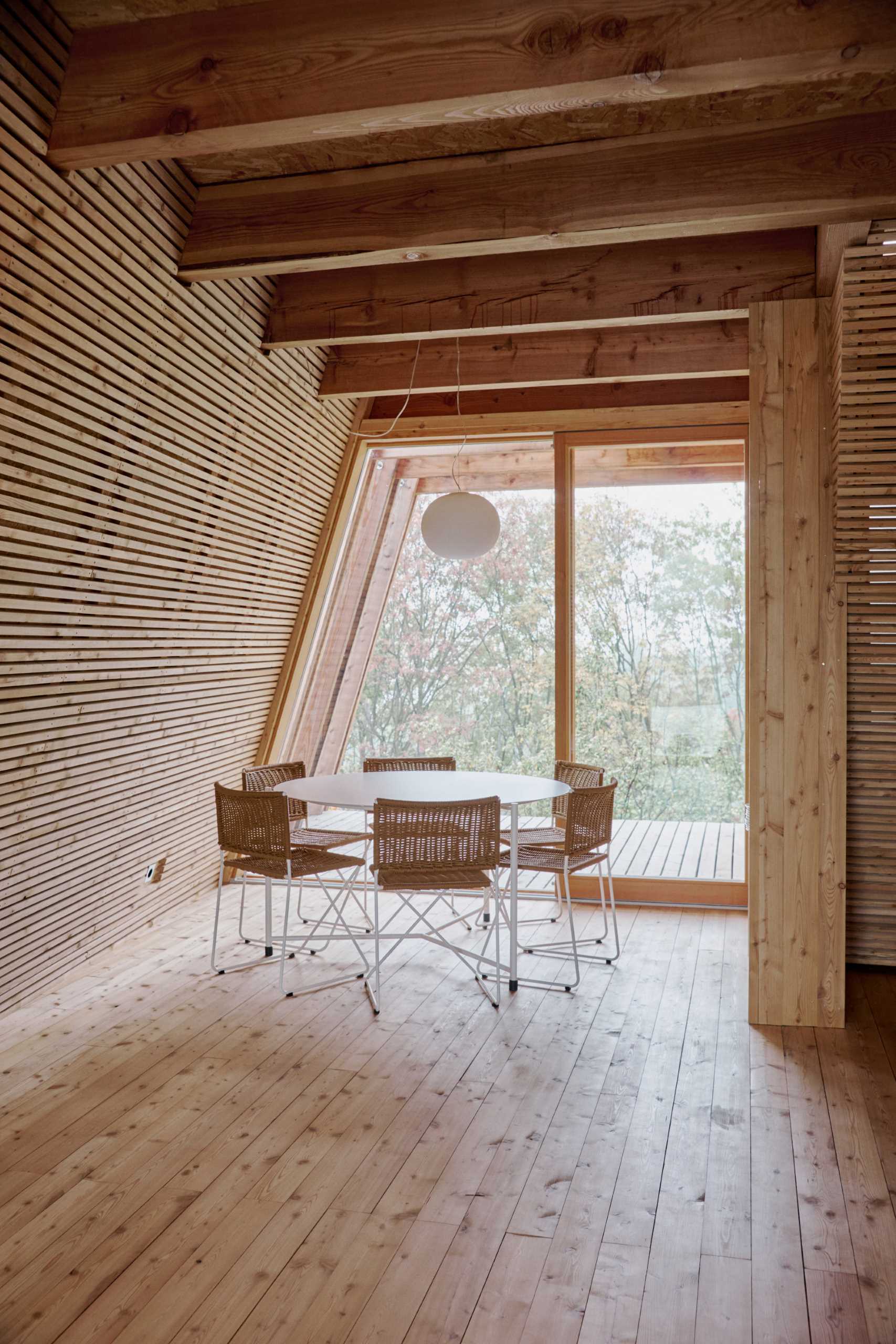 A wood a-frame cabin has a breakfast area.