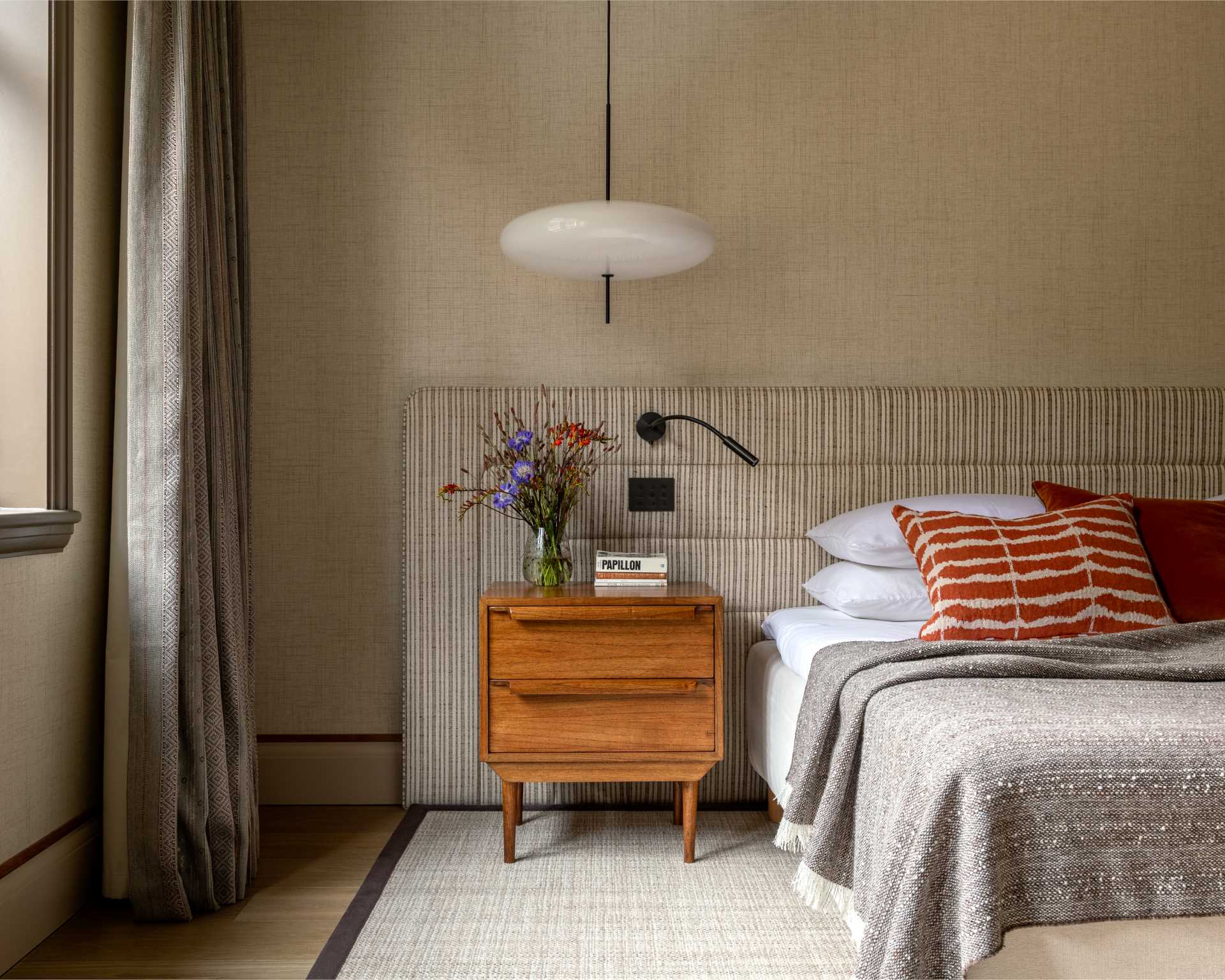 In this contemporary bedroom, there's a neutral palette with pops of color.