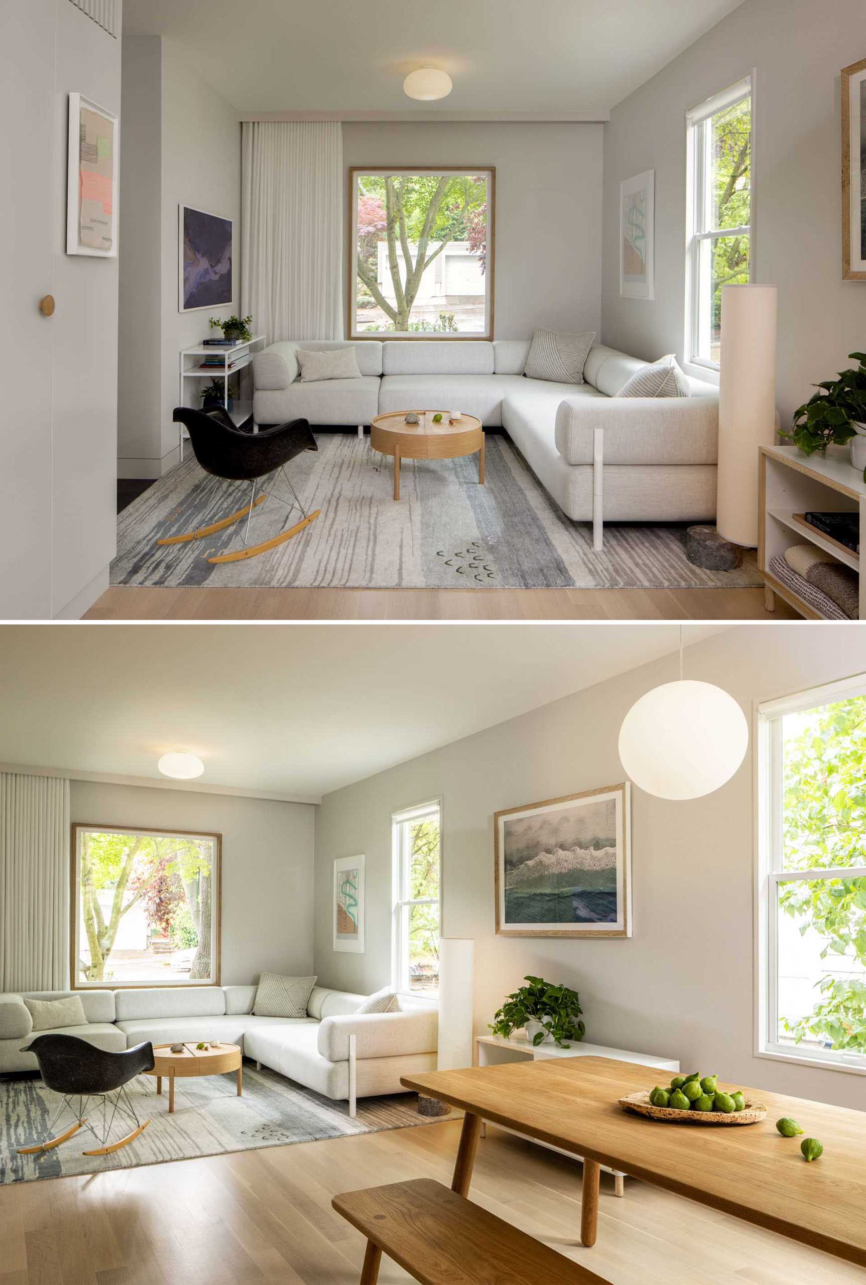 This remodeled living room flows through to the dining room with a wood table and bench seating. A work area with a desk and shelving is located on the opposite wall.