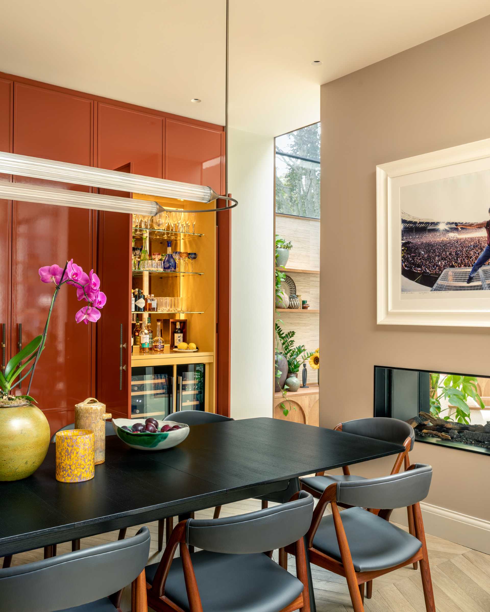 A contemporary dining room with a double-sided fireplace.