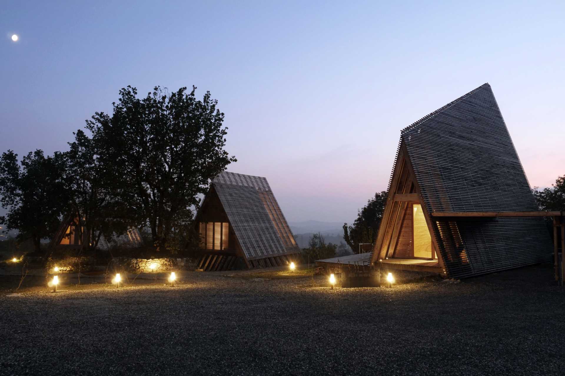 At night the landscaping around the cabins is highlighted by outdoor lights.