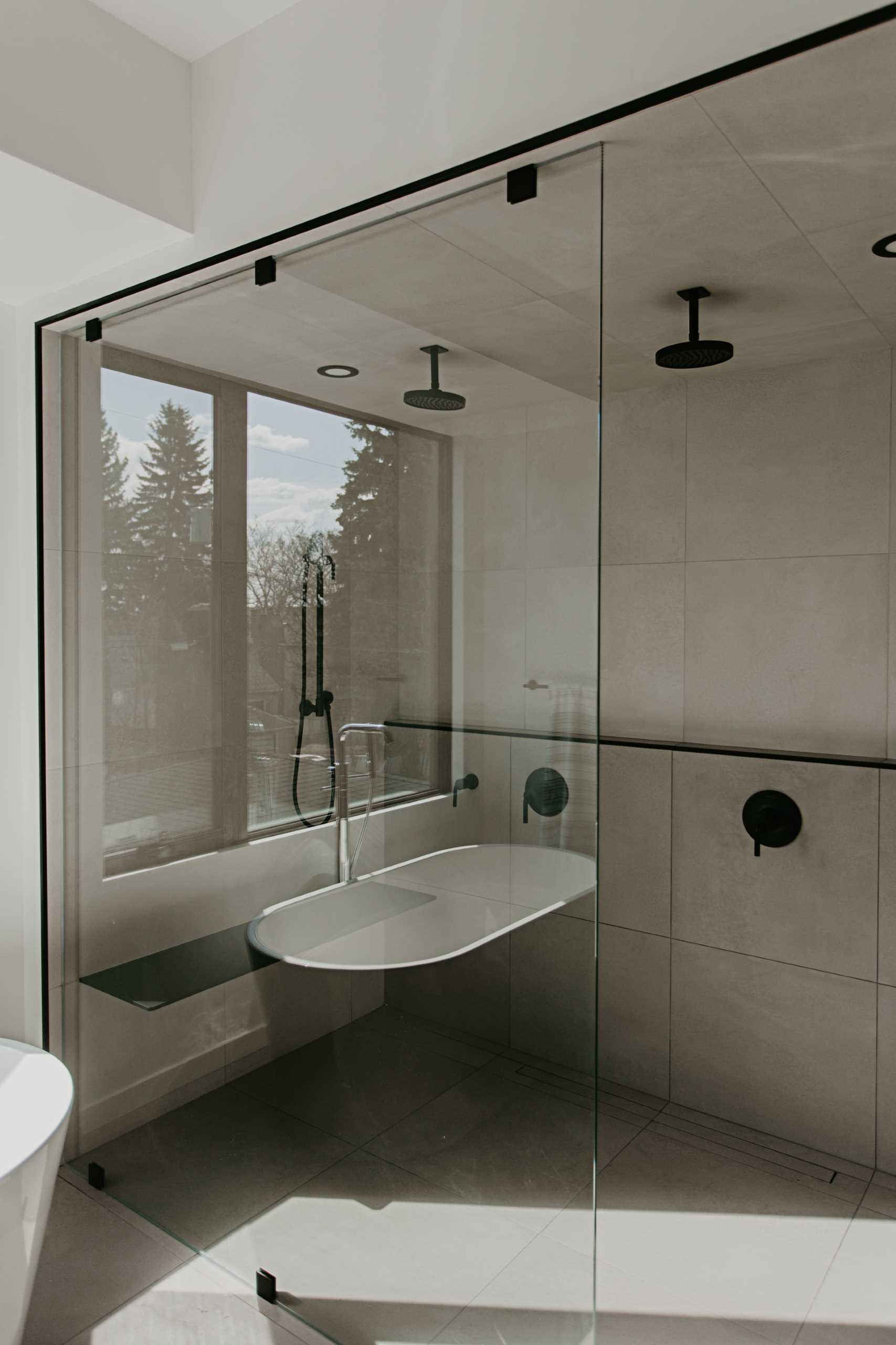 A walk-in shower with black details, a bench, and a shelf.