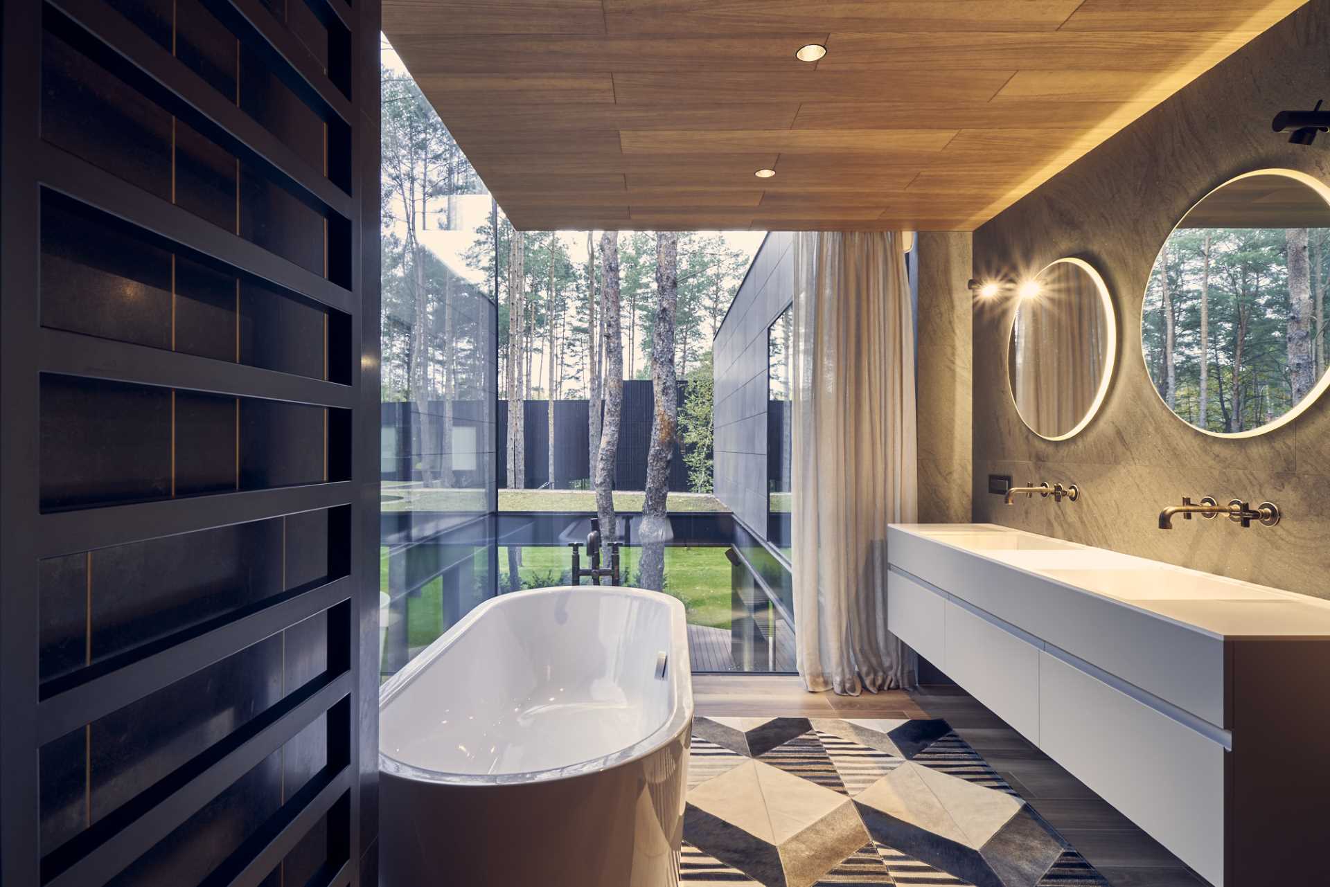 A modern bathroom with floor-to-ceiling windows.