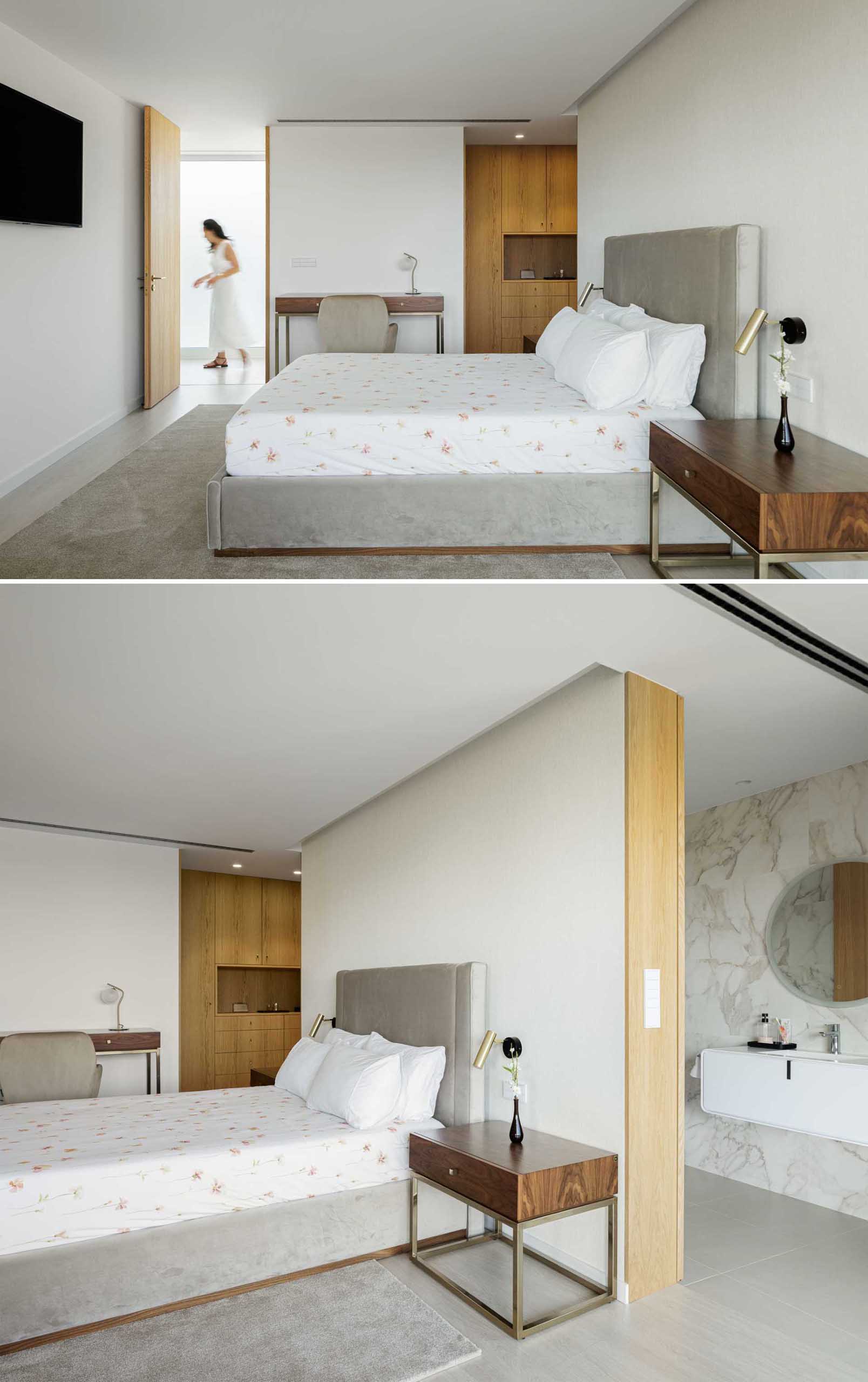 In this modern bedroom a wall separates the sleeping area from the en-suite bathroom. There's also a closet area lined with wood.
