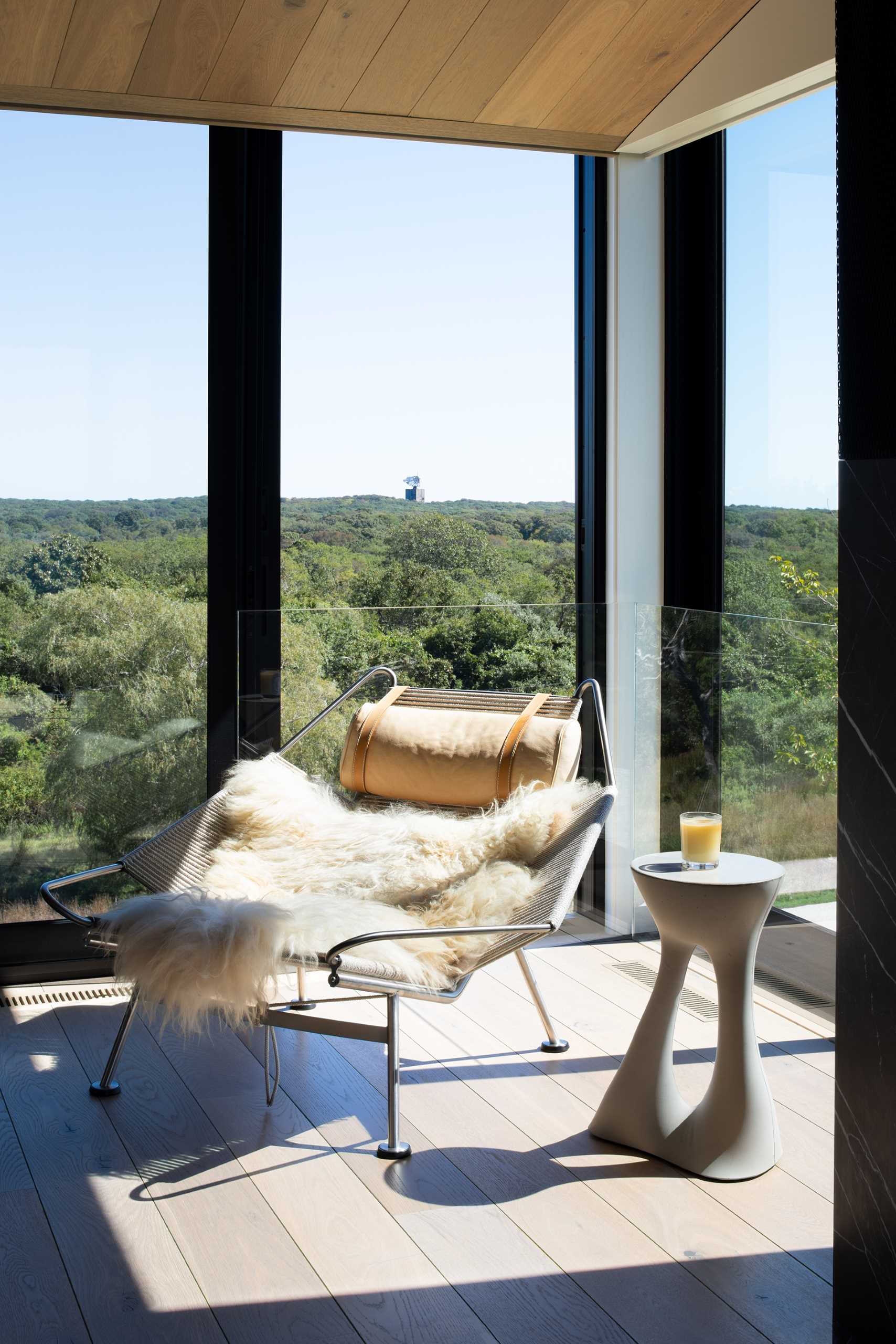 A modern home with floor-to-ceiling windows with black frames.