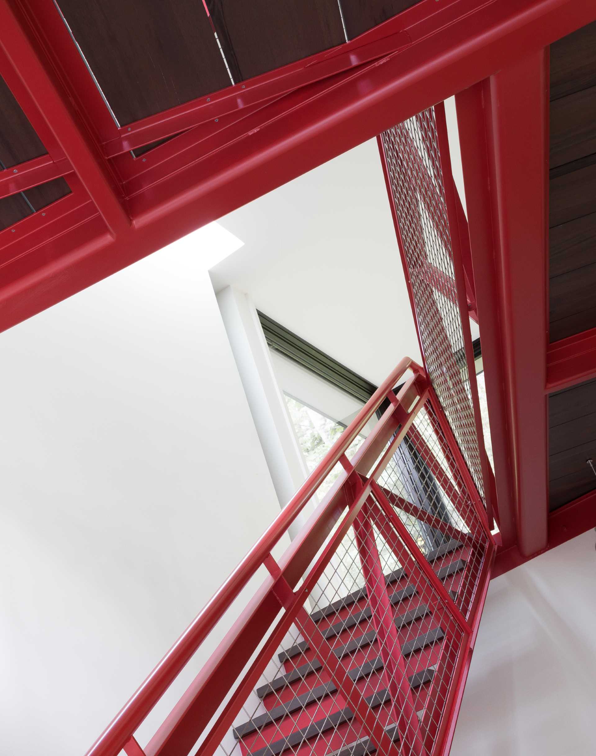 A modern house with a red staircase.