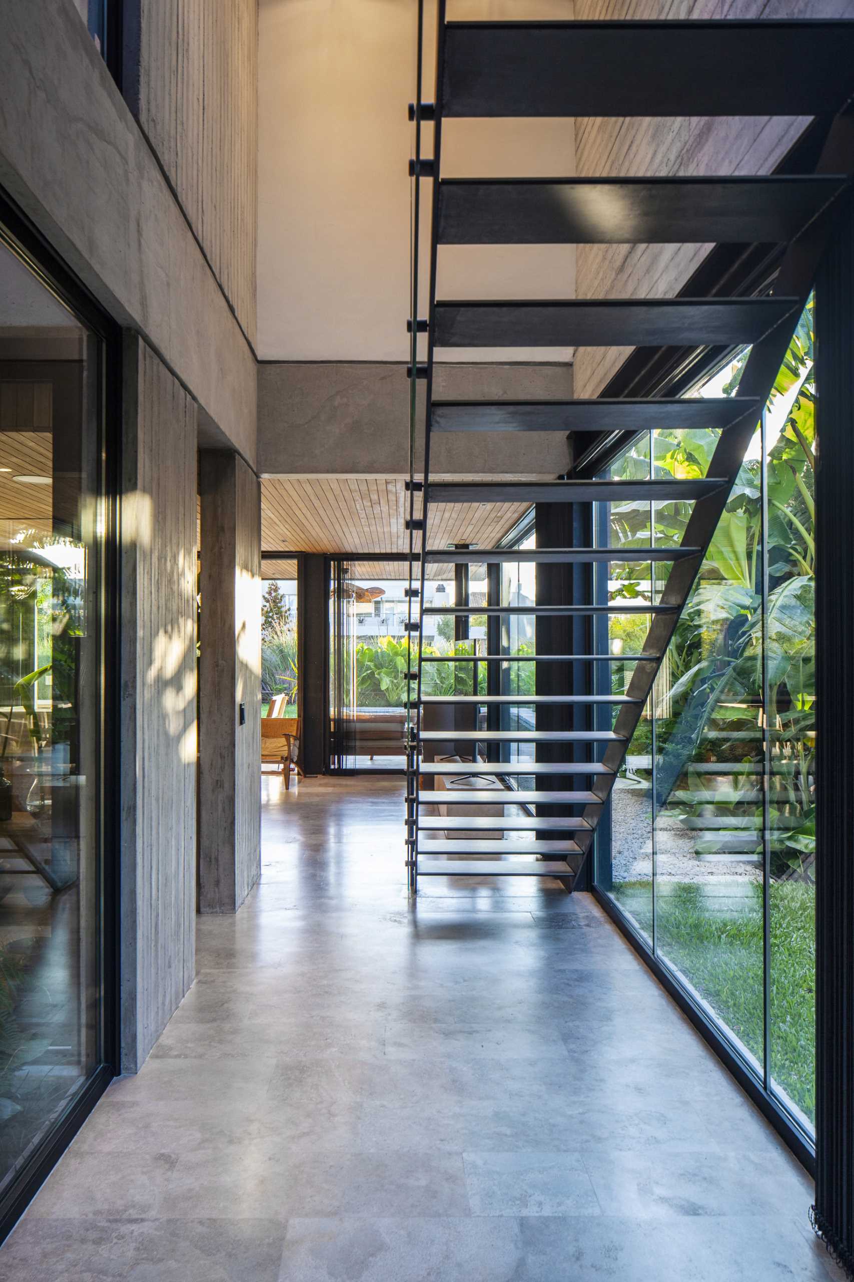 A modern home with a minimalist black staircase.