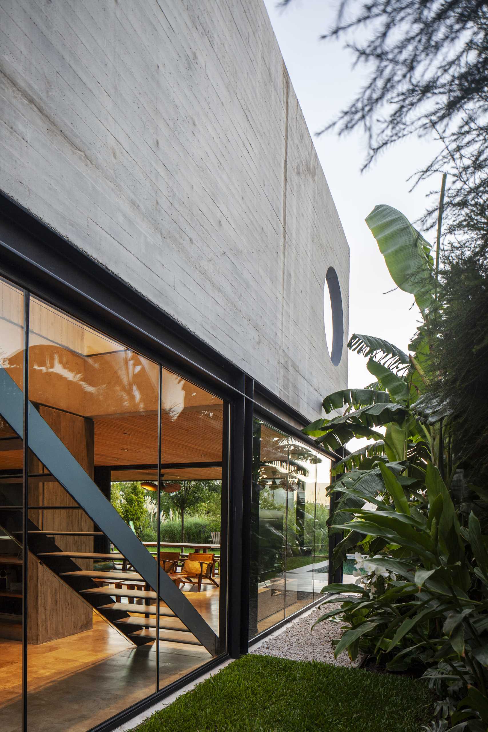 A modern home with glass and concrete walls.