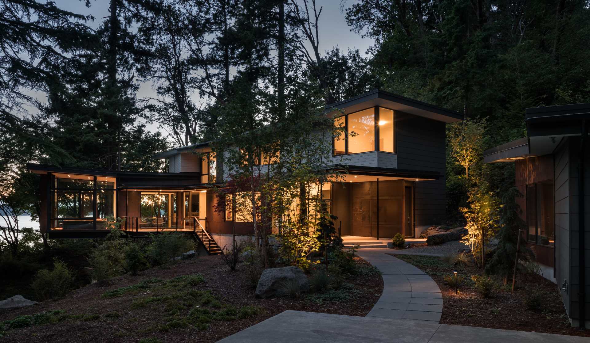 A modern home in the trees with a suspended living room.