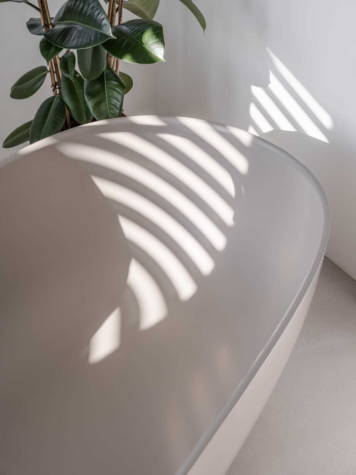 A modern bathroom with a freestanding bathtub.