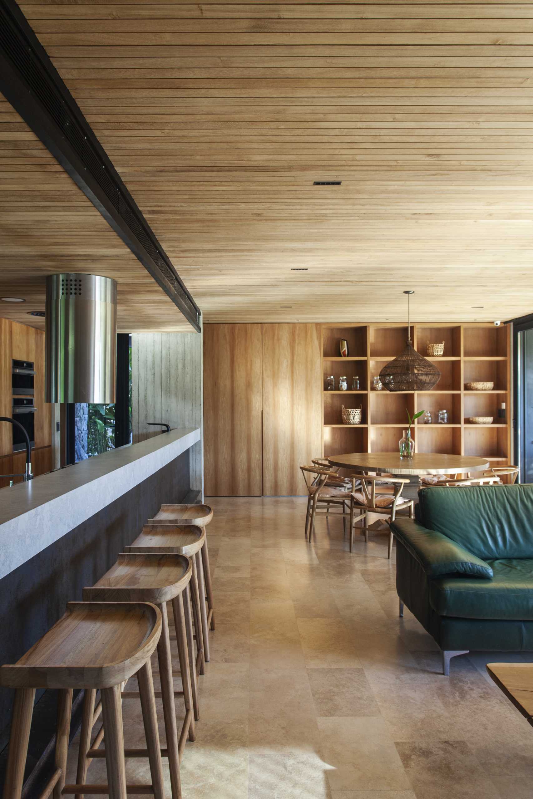 A modern home interior with an open floor plan and wood ceiling.