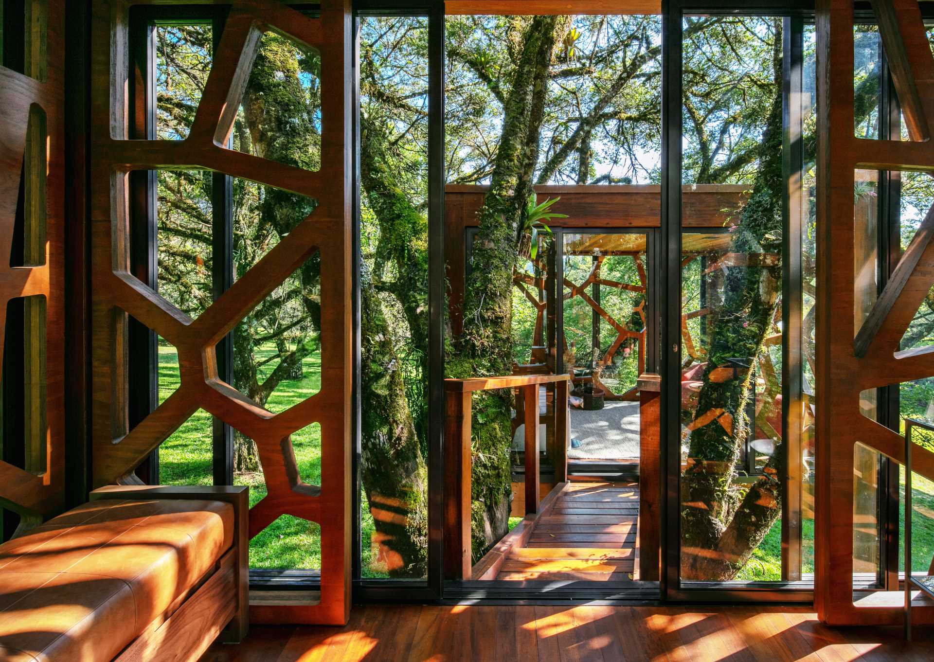 A modern tree house with two rooms that both have leaf-inspired decorative elements.