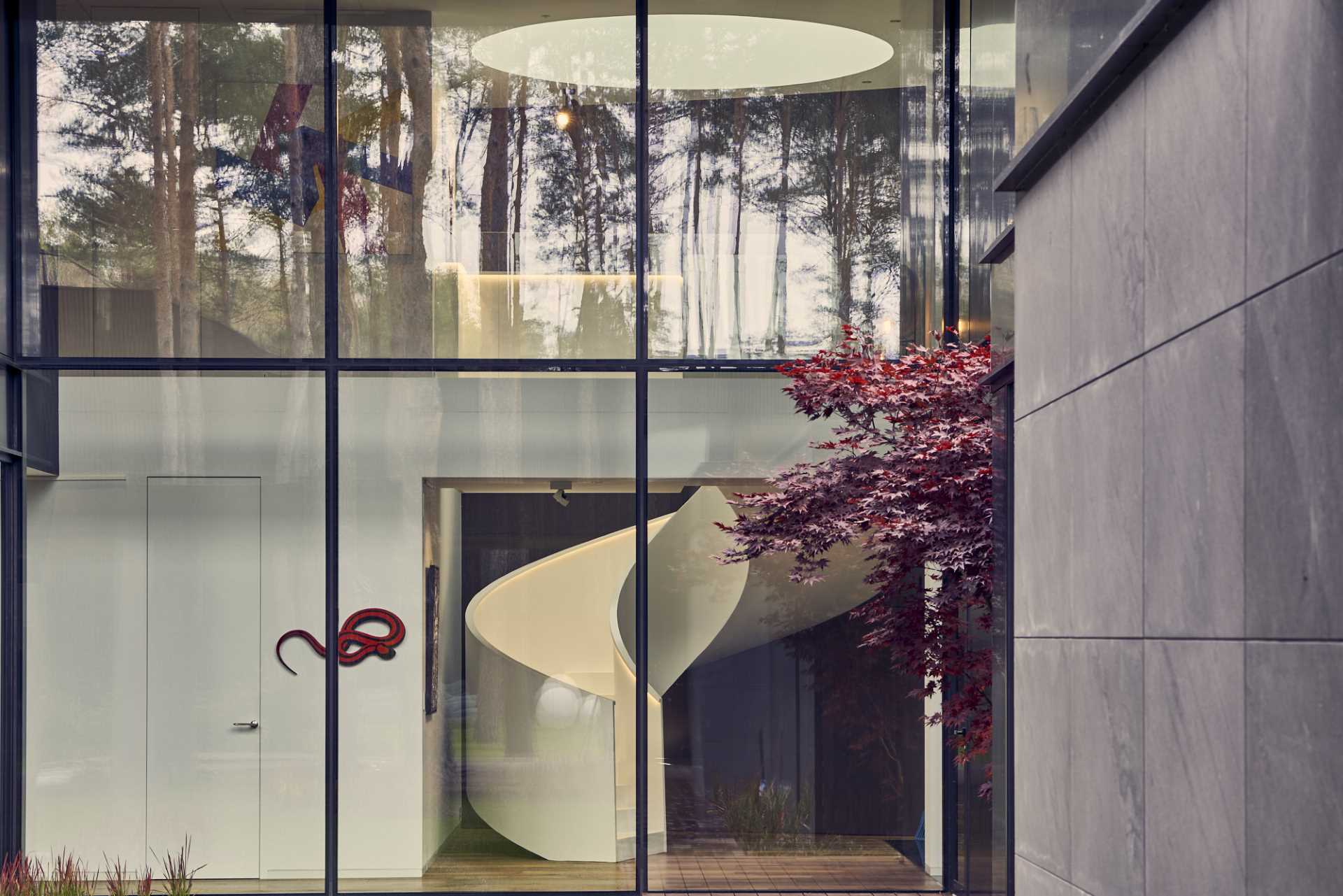 Sculptural white spiral staircase with hidden lighting.