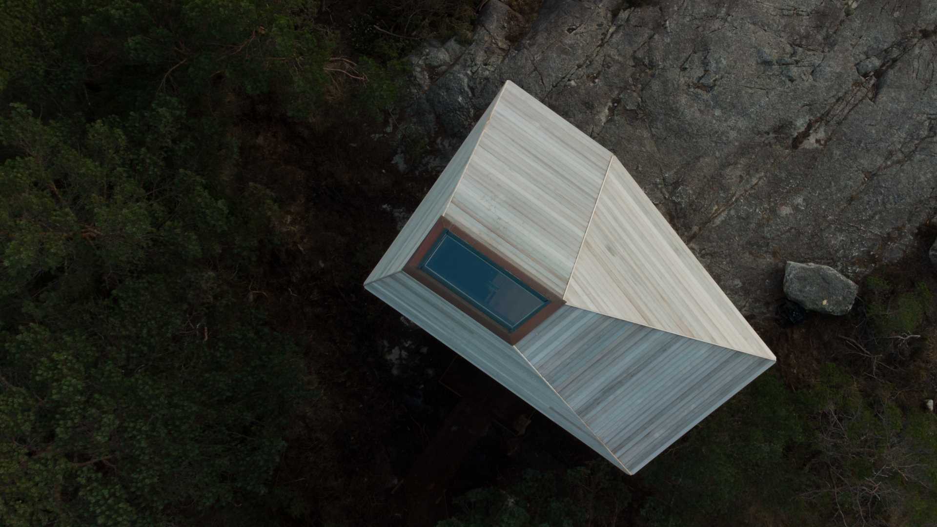 A small wood cabin with a skylight.