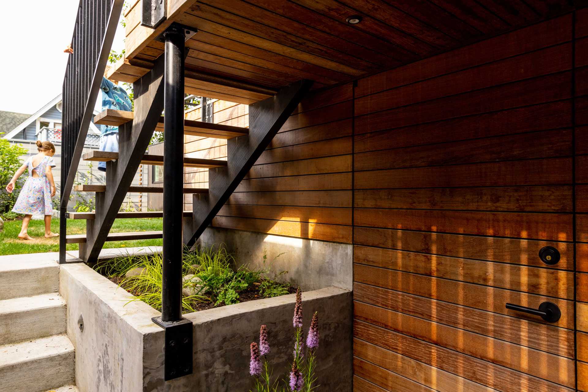 New stairs from the deck connect down to the expansive remodeled family room complete with a custom Murphy bed for guests, an enclosed laundry and utility room, and concealed under-stair storage.