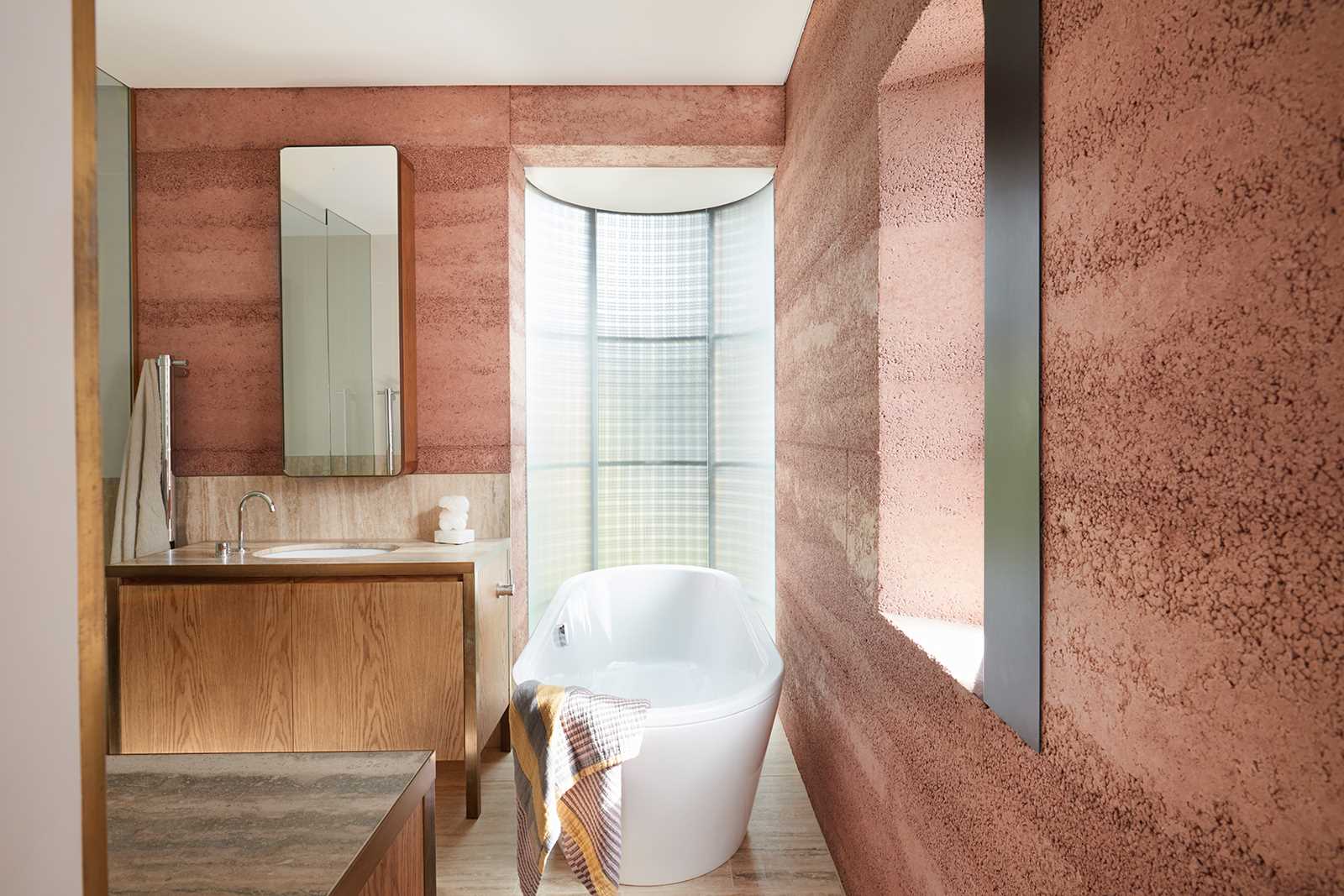 A modern bathroom with rammed earth walls.