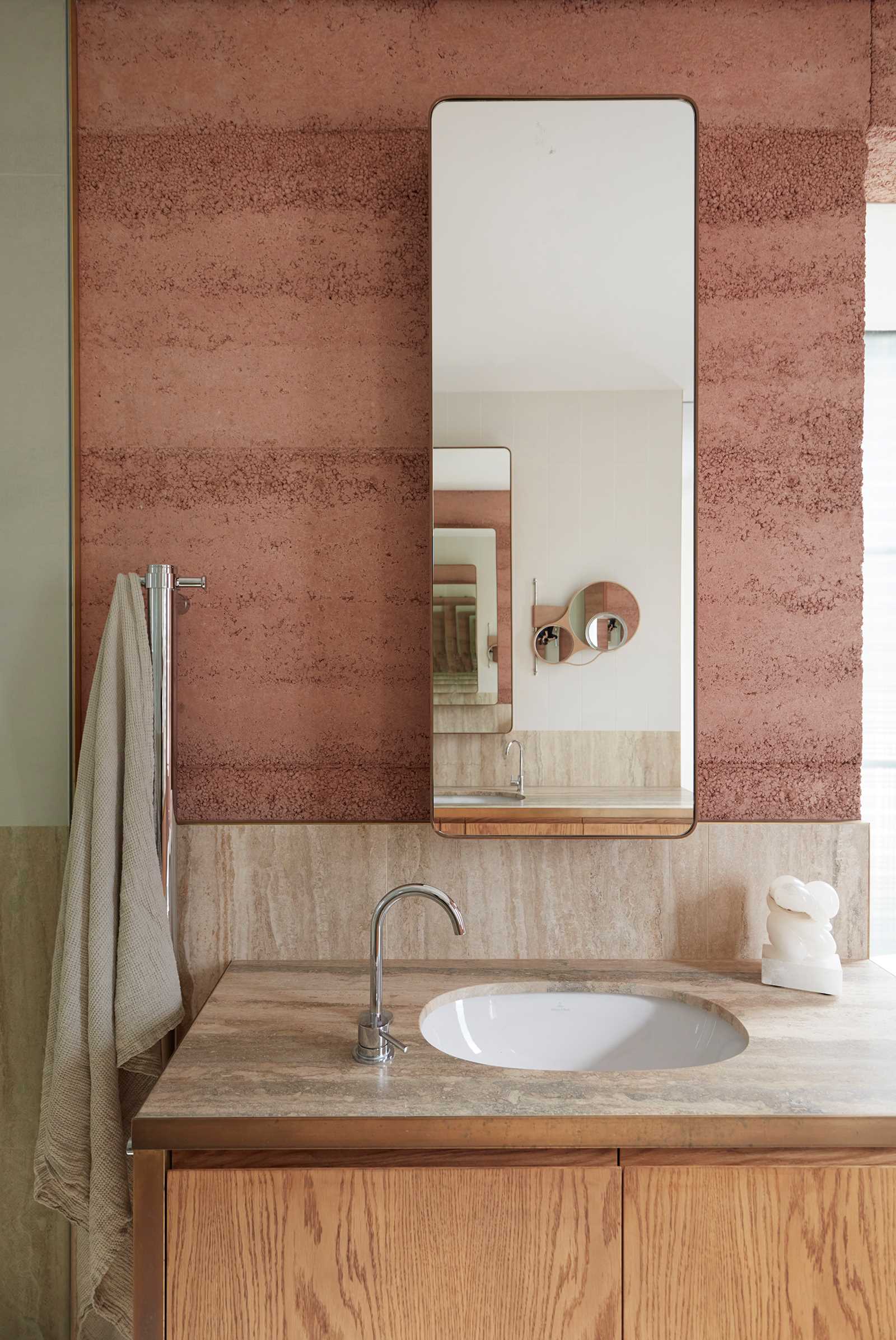 A modern bathroom with rammed earth walls.