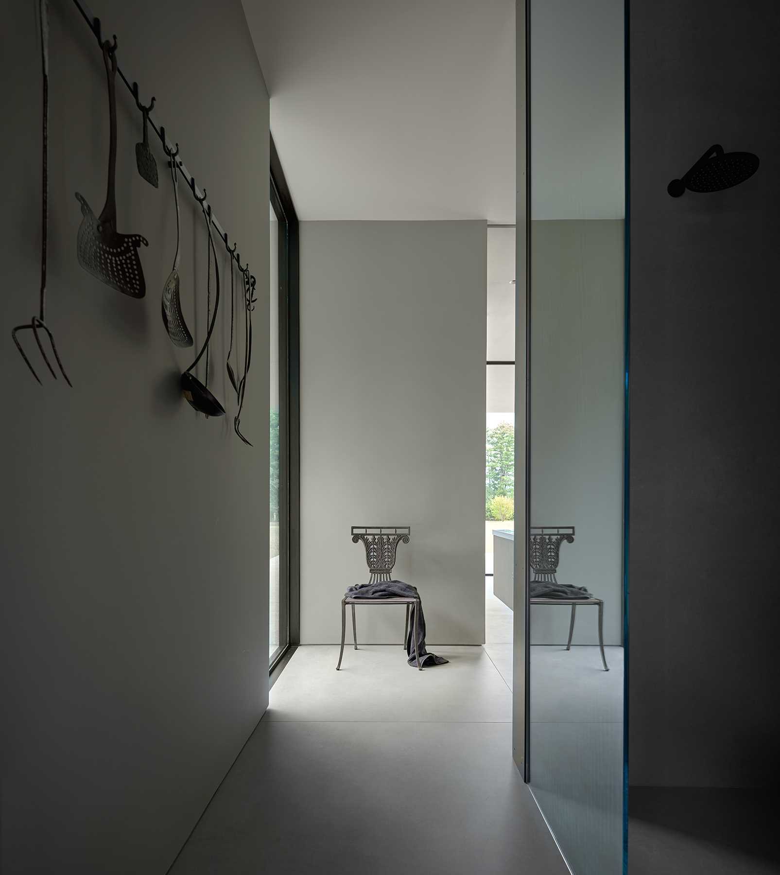 A primary bathroom becomes the backdrop for the homeowners collection of art and furniture.