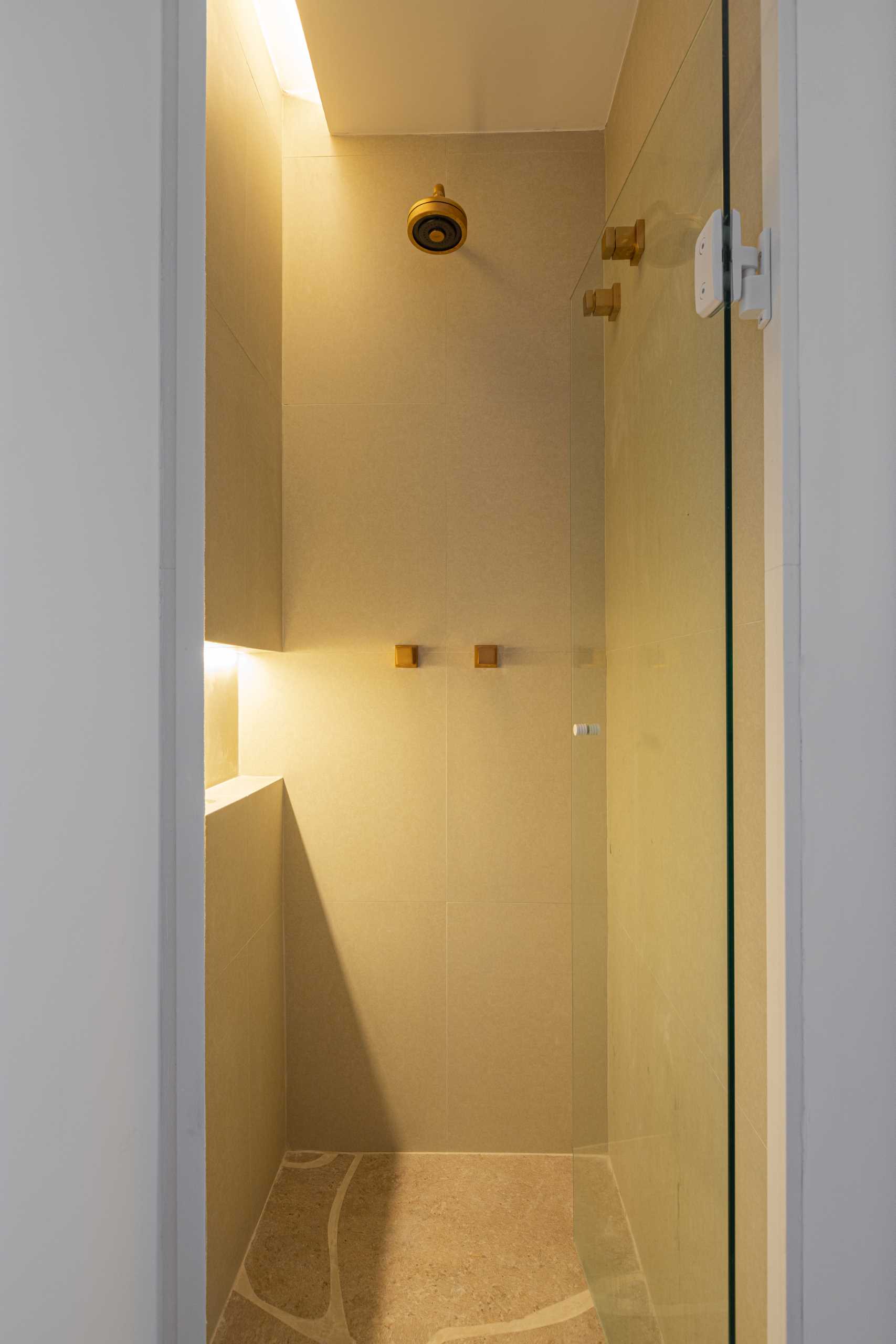 A shower with hidden lighting and a shelving niche.