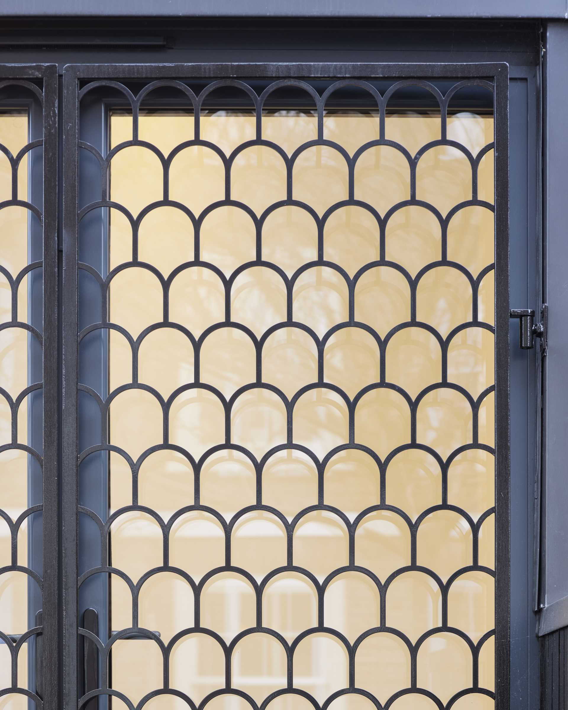 Arches appear at the entry of these townhouses in the form of metal shutters on the windows adjacent to the front doors.