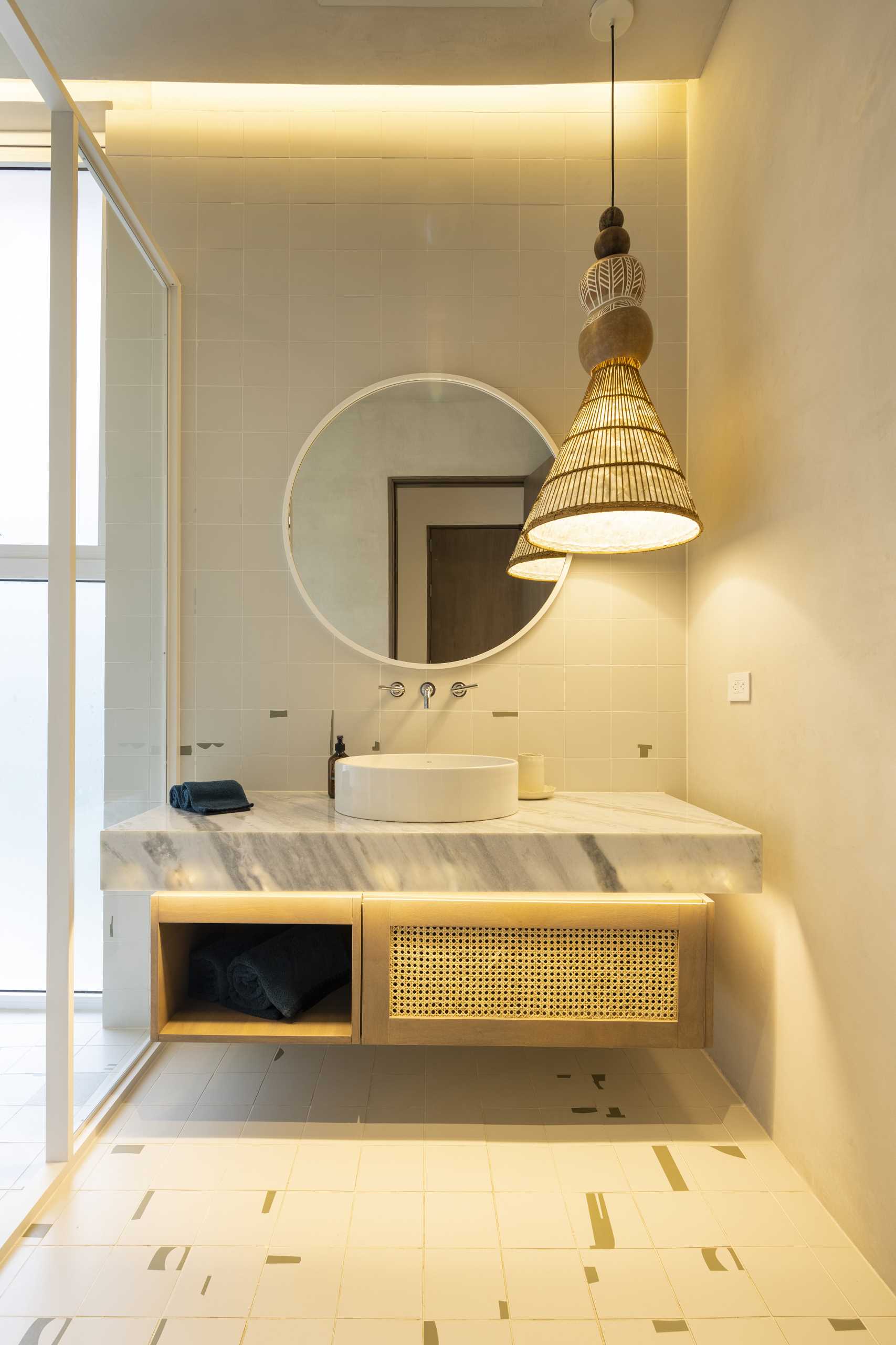 A modern bathroom with hidden lighting, a floating vanity, and a walk-in shower.