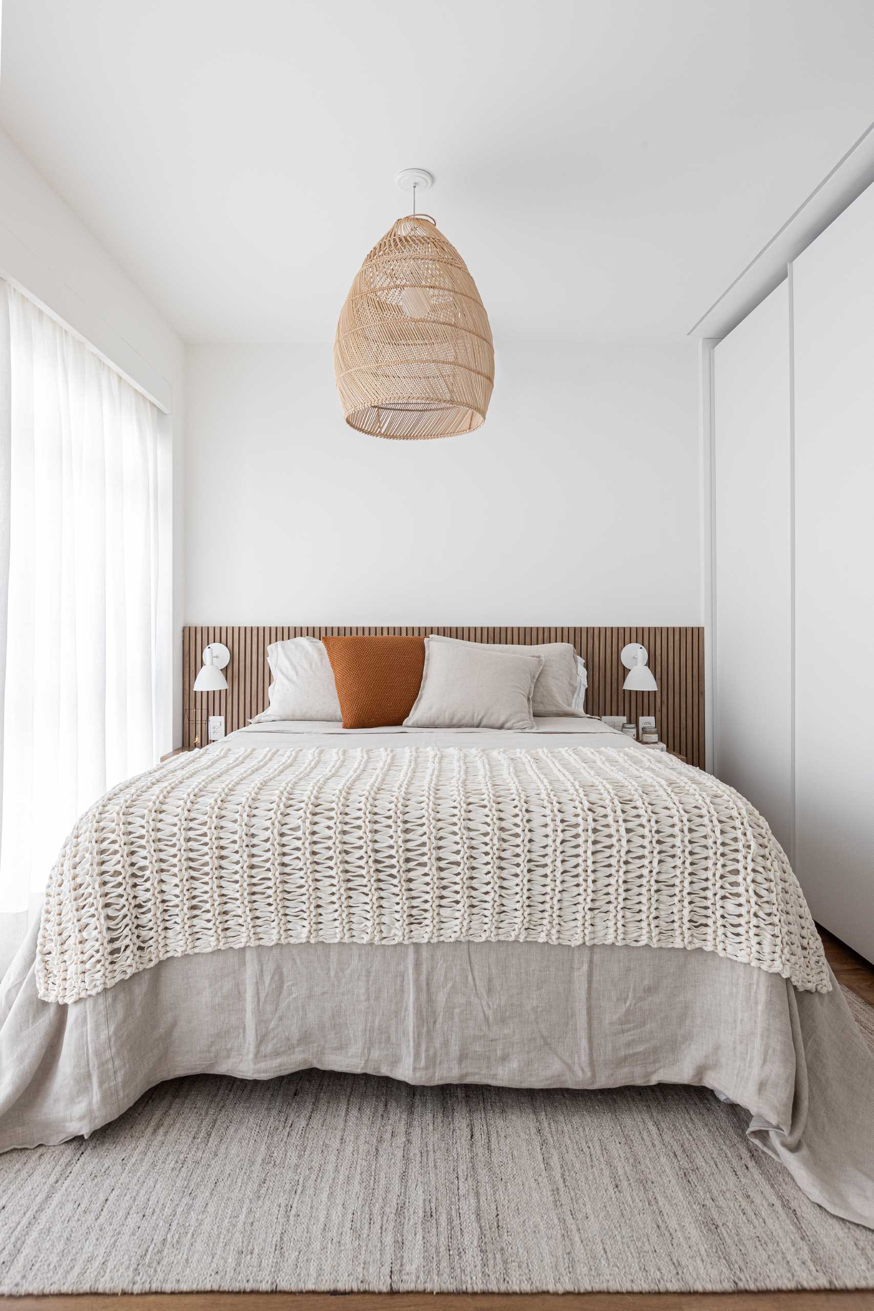 A modern bedroom with a natural color palette.