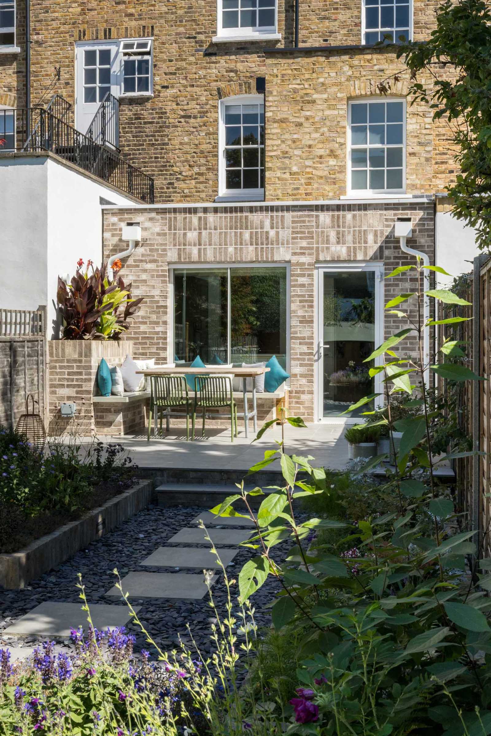A Grade II listed terrace home in Islington, England, received a new brick addition with outdoor seating.
