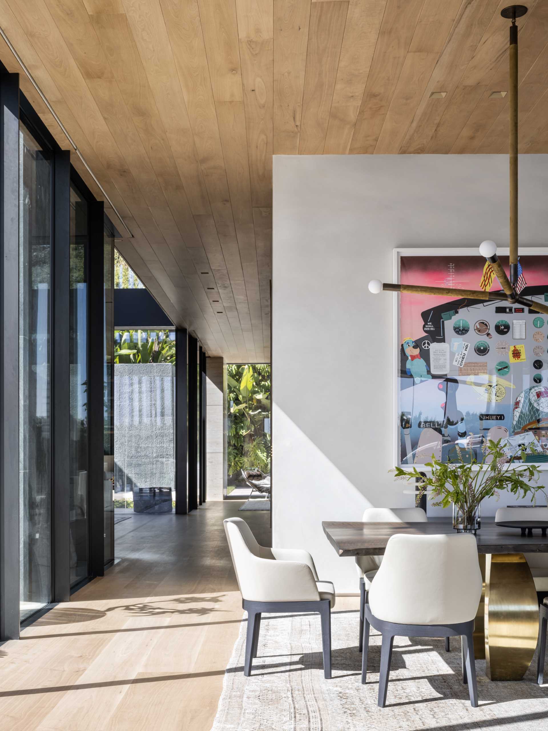 A modern dining area with a large wood table.