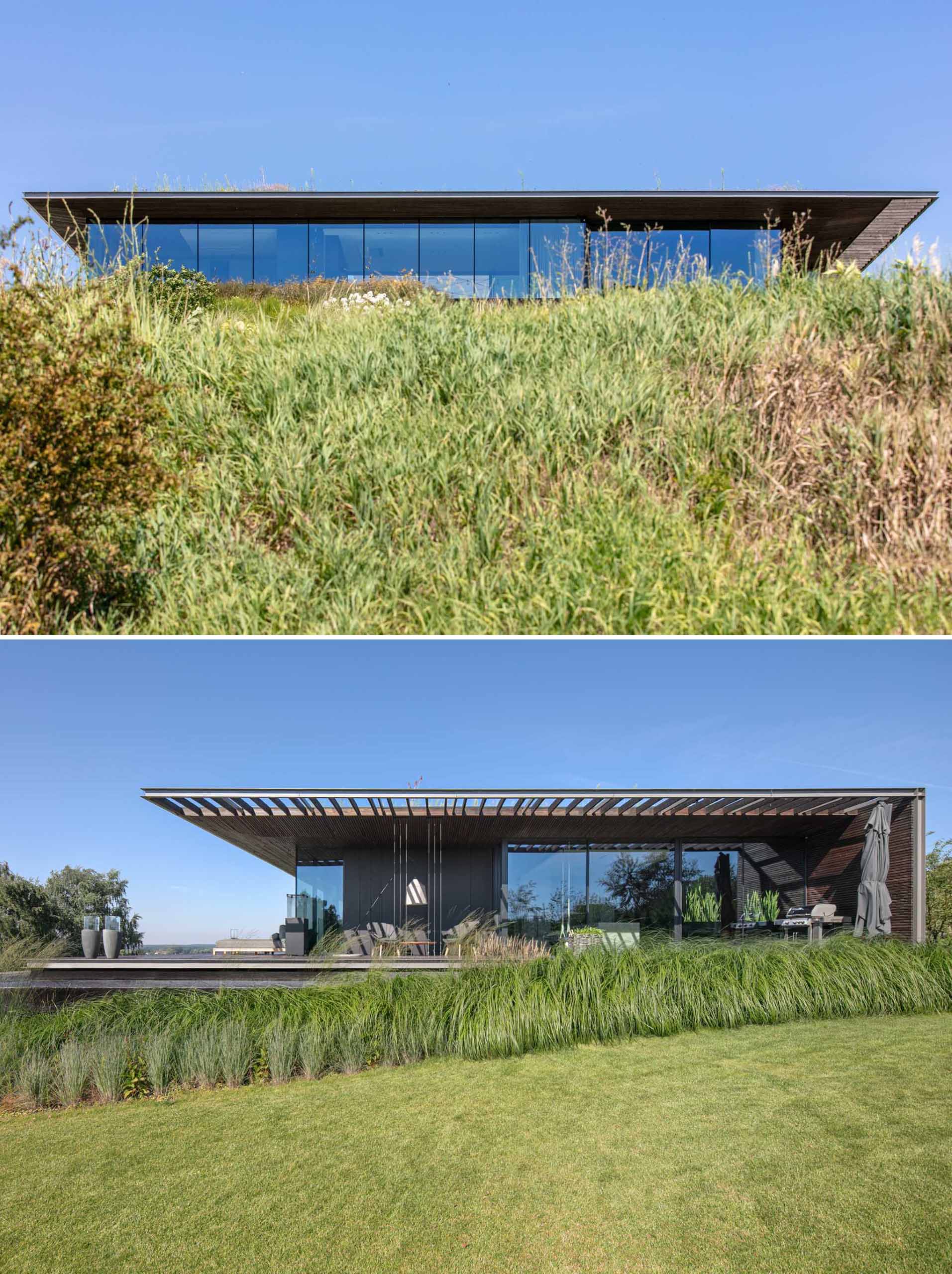 A modern house that somewhat blends into the sloped landscape.