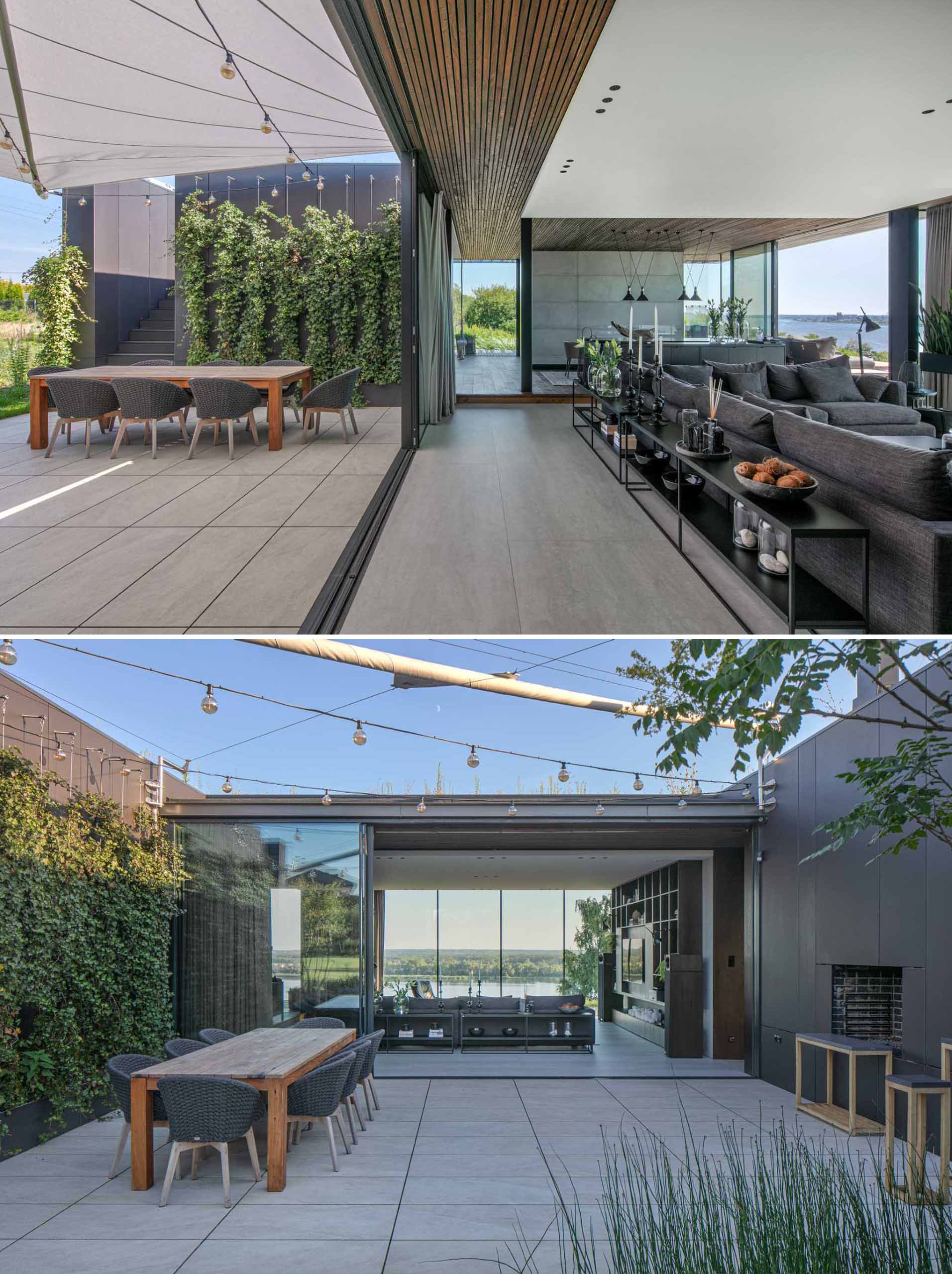 A modern house with an outdoor dining area that's lit with string lights.