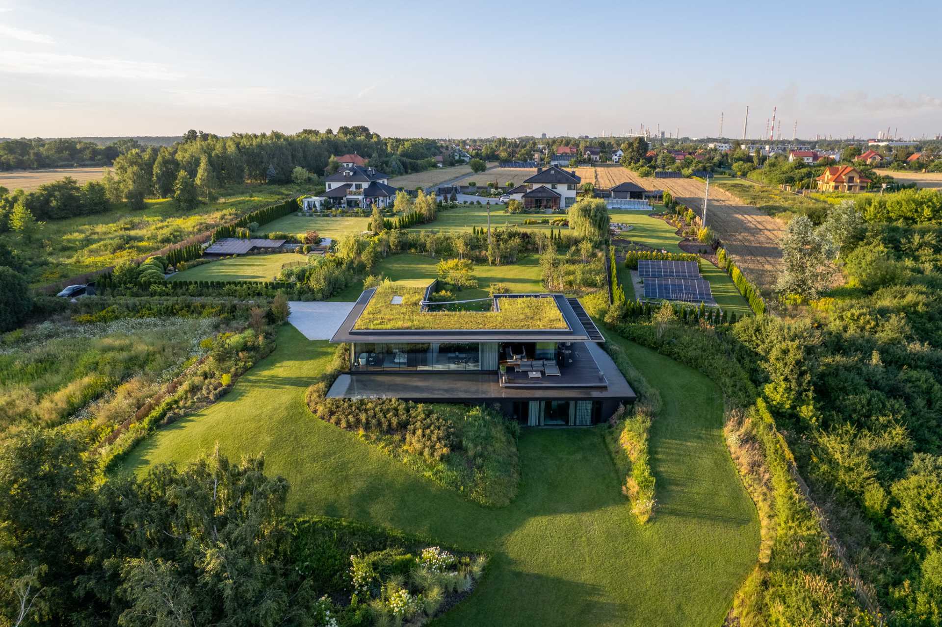 This modern home has been designed to subtly integrate into the natural shape of the land, and allows for a usable green roof.