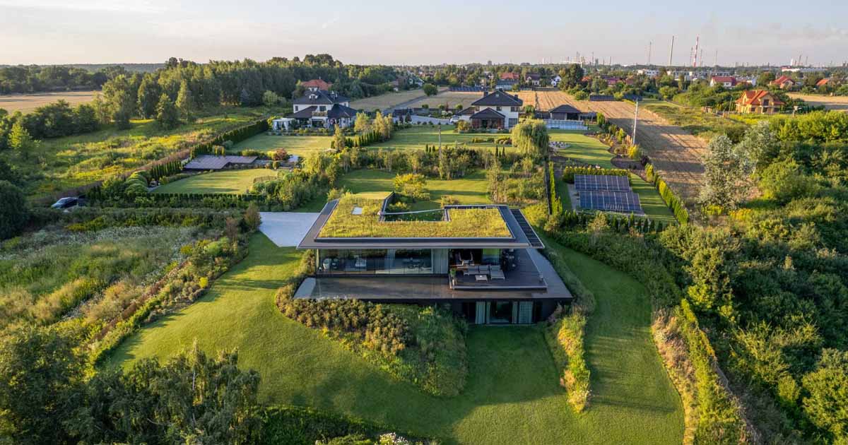 A Large Green Roof Covers This Riverside Home