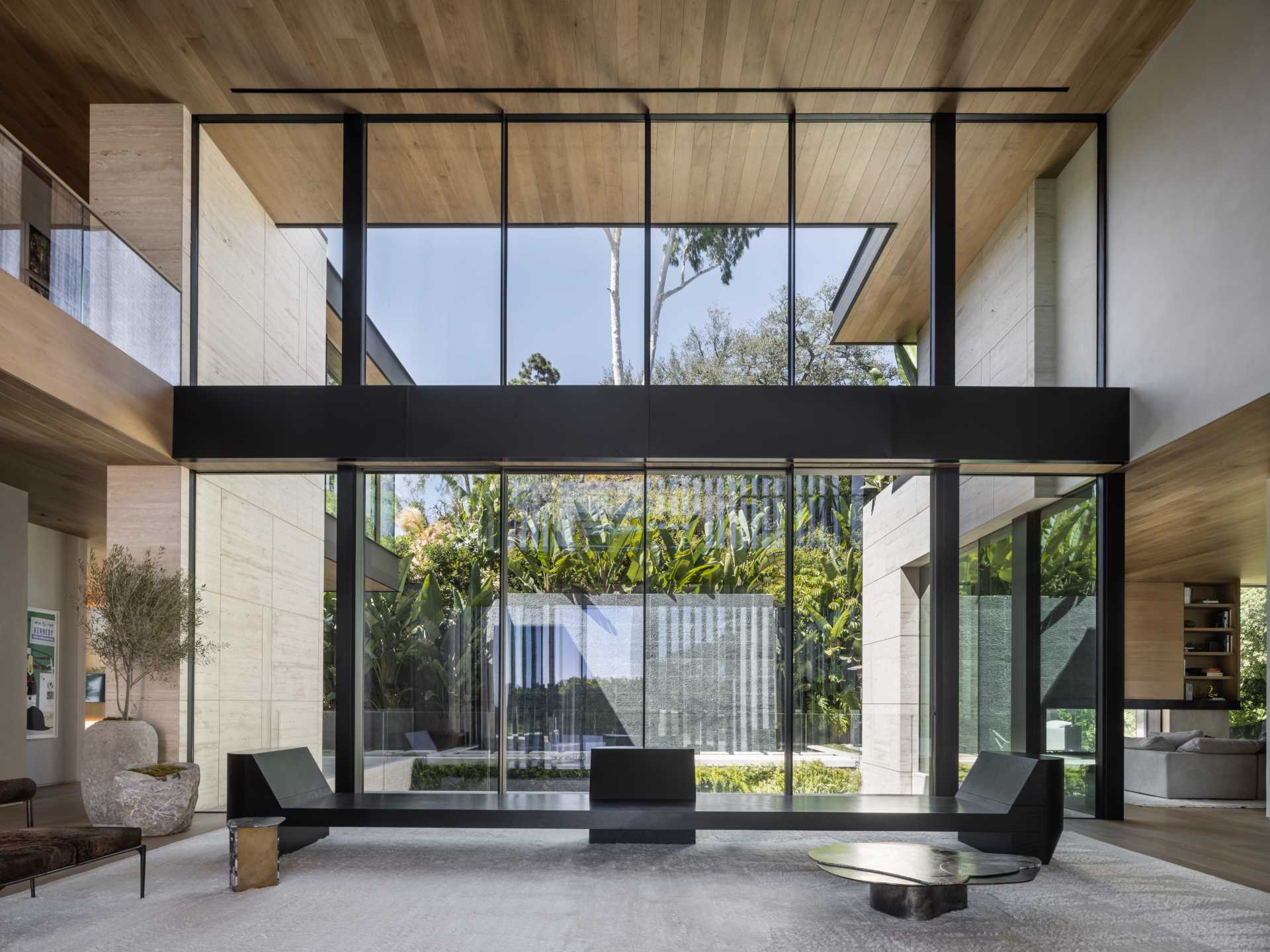 A modern house with a double-height foyer that has a wall of windows.