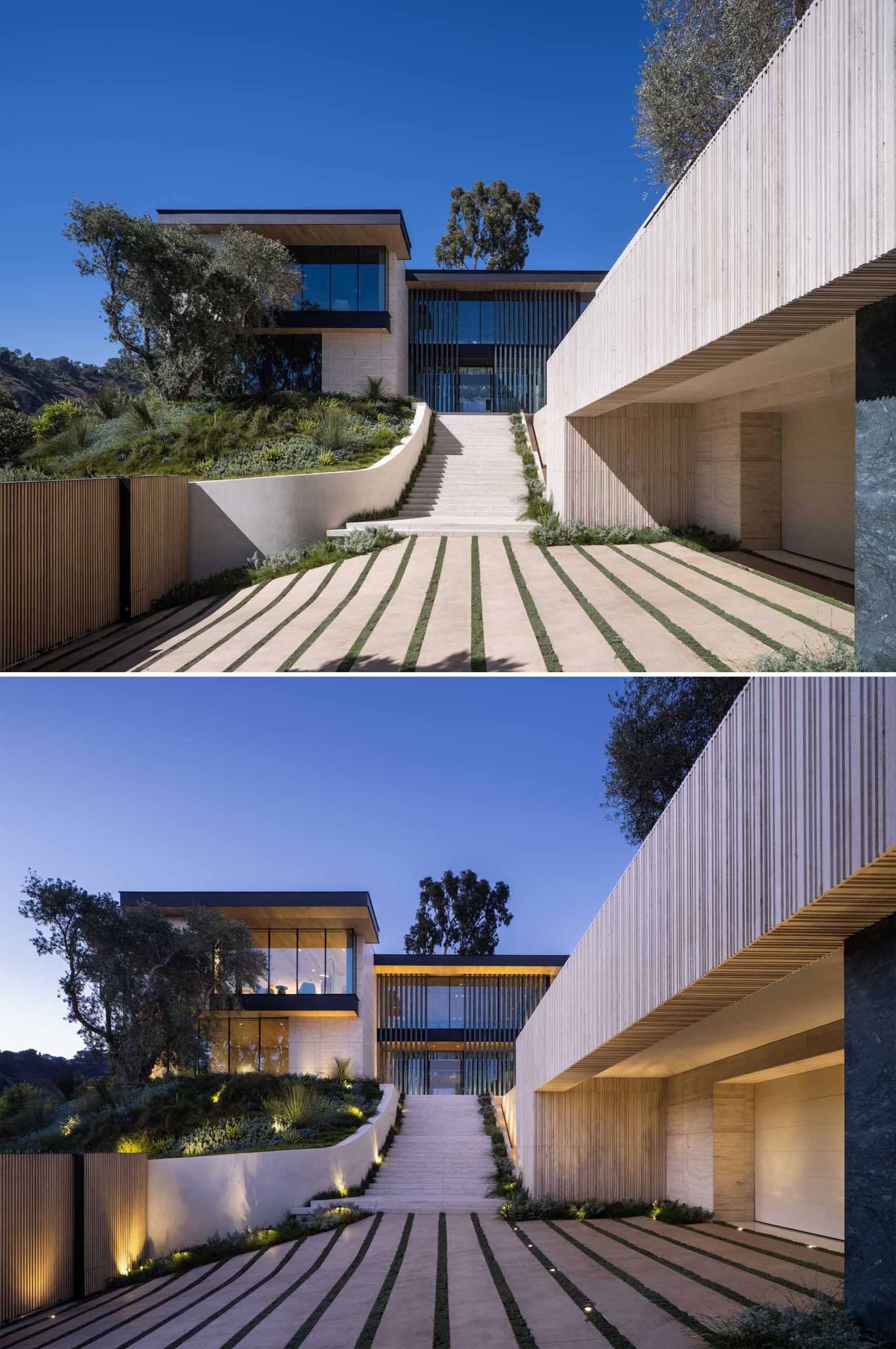 Outdoor lighting highlights the design features and landscaping of this house.