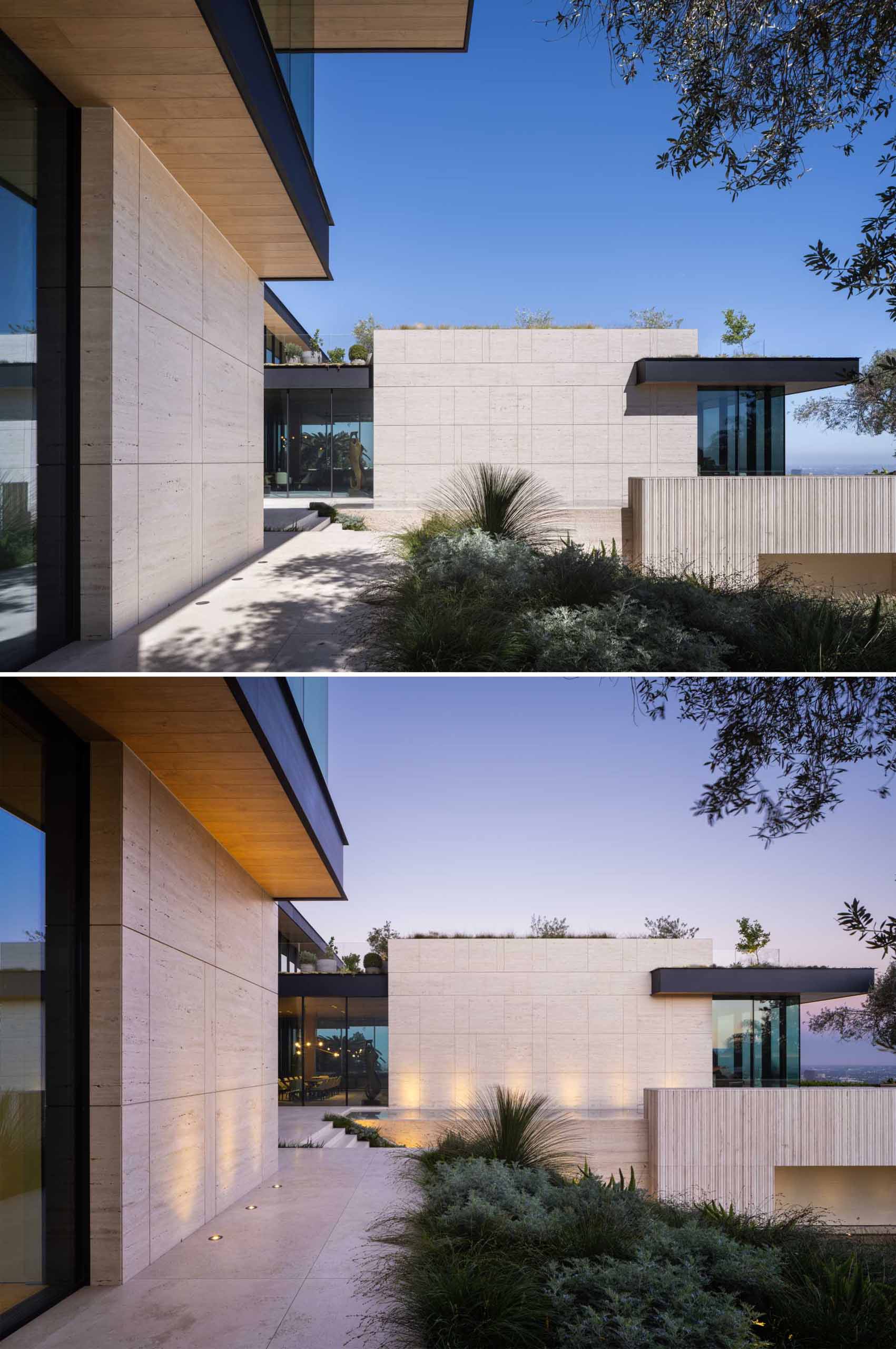 Outdoor lighting highlights the design features and landscaping of this house.