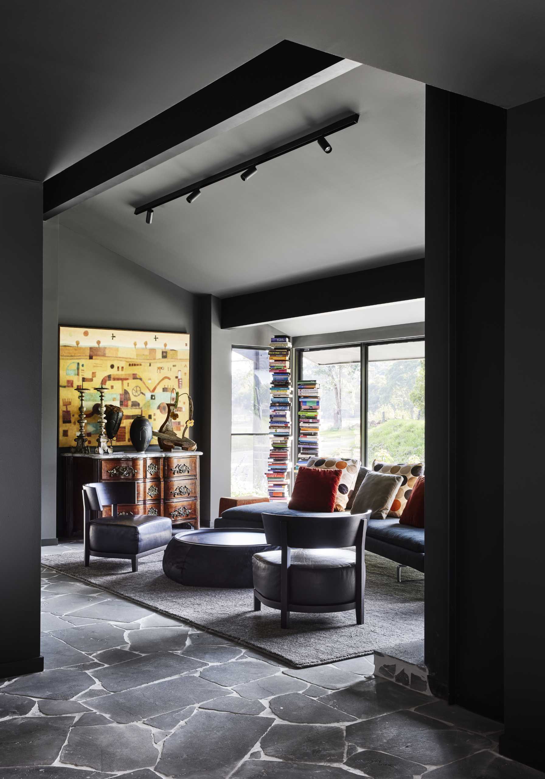 A modern lounge room with dark walls.