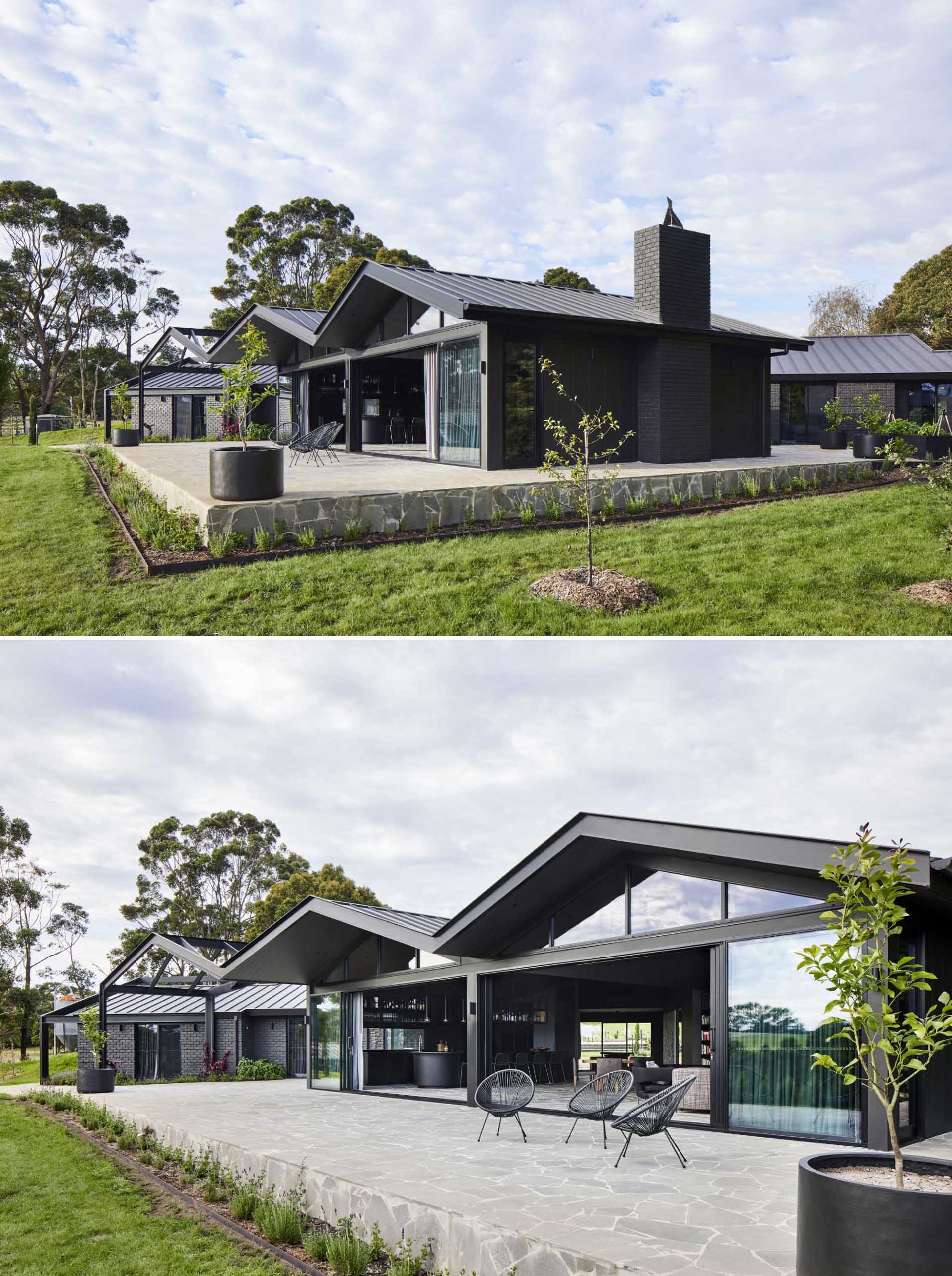 A modern farmhouse with a pitched roof and bluestone crazy paving that's featured on the terrace and the interior.